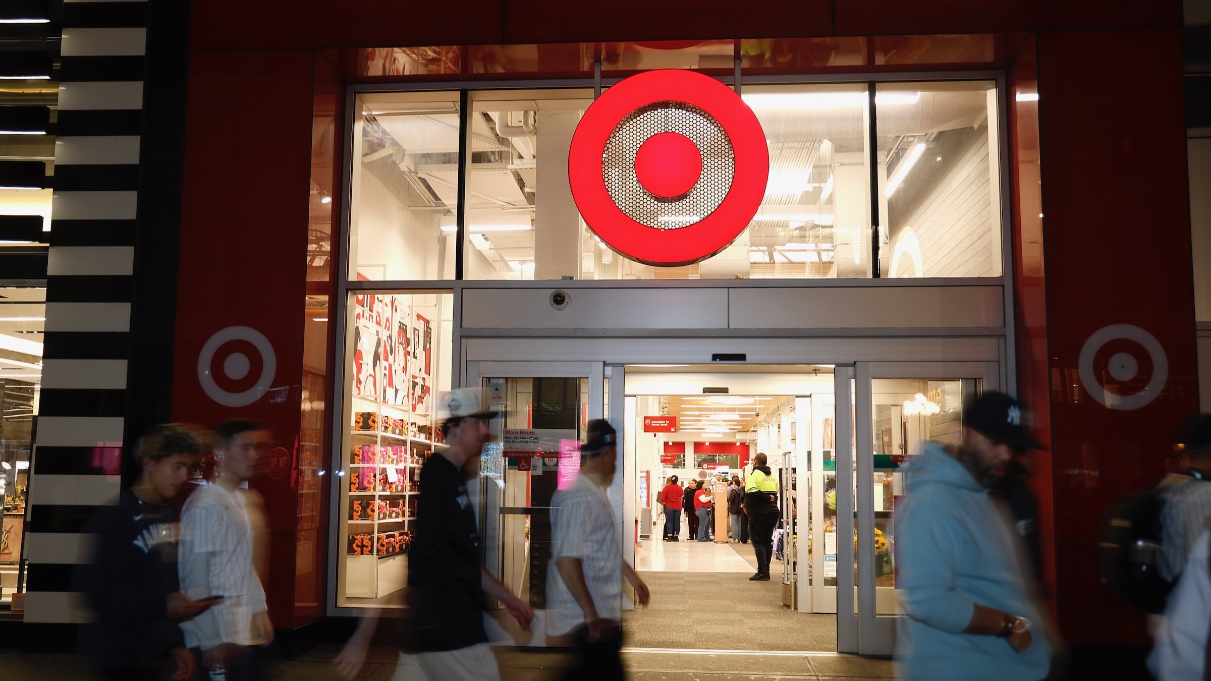 people walk outside a target store at night