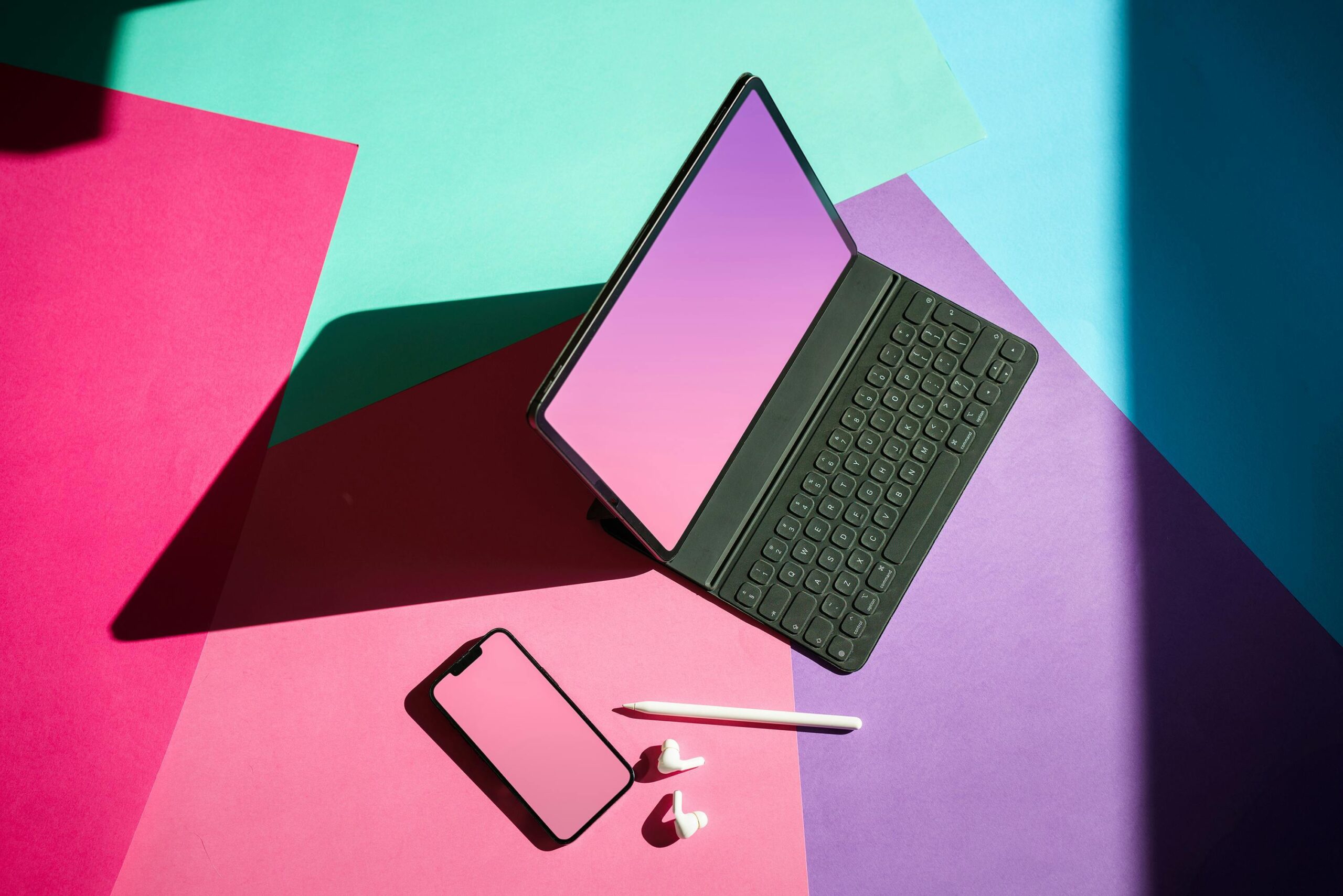 laptop on green and pink surface