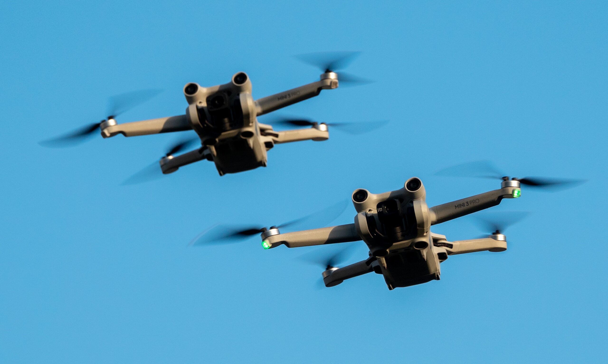 DJI drones fly above the ground on November 8, 2025