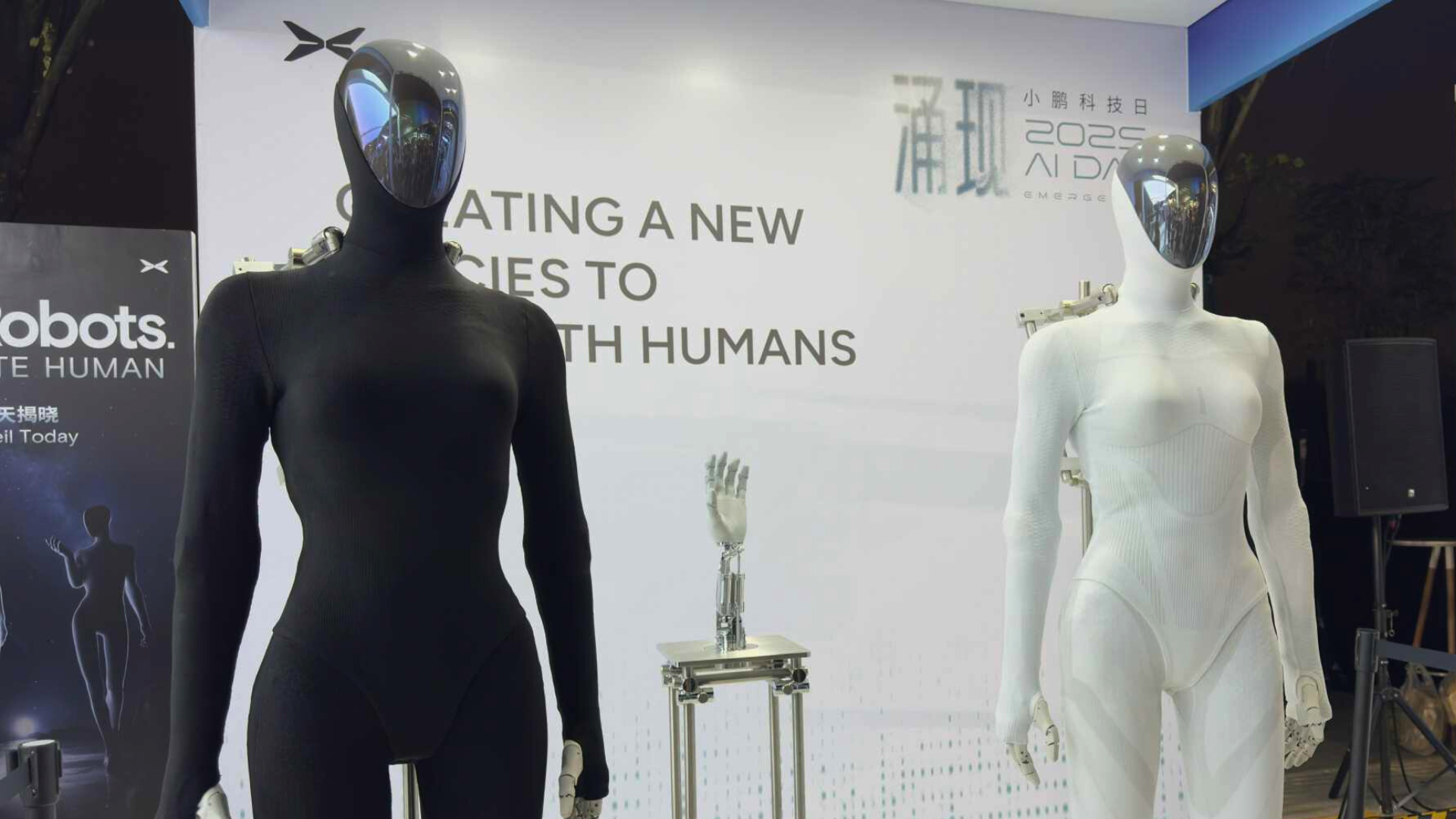 Two XPENG IRON humanoid robots standing side by side.