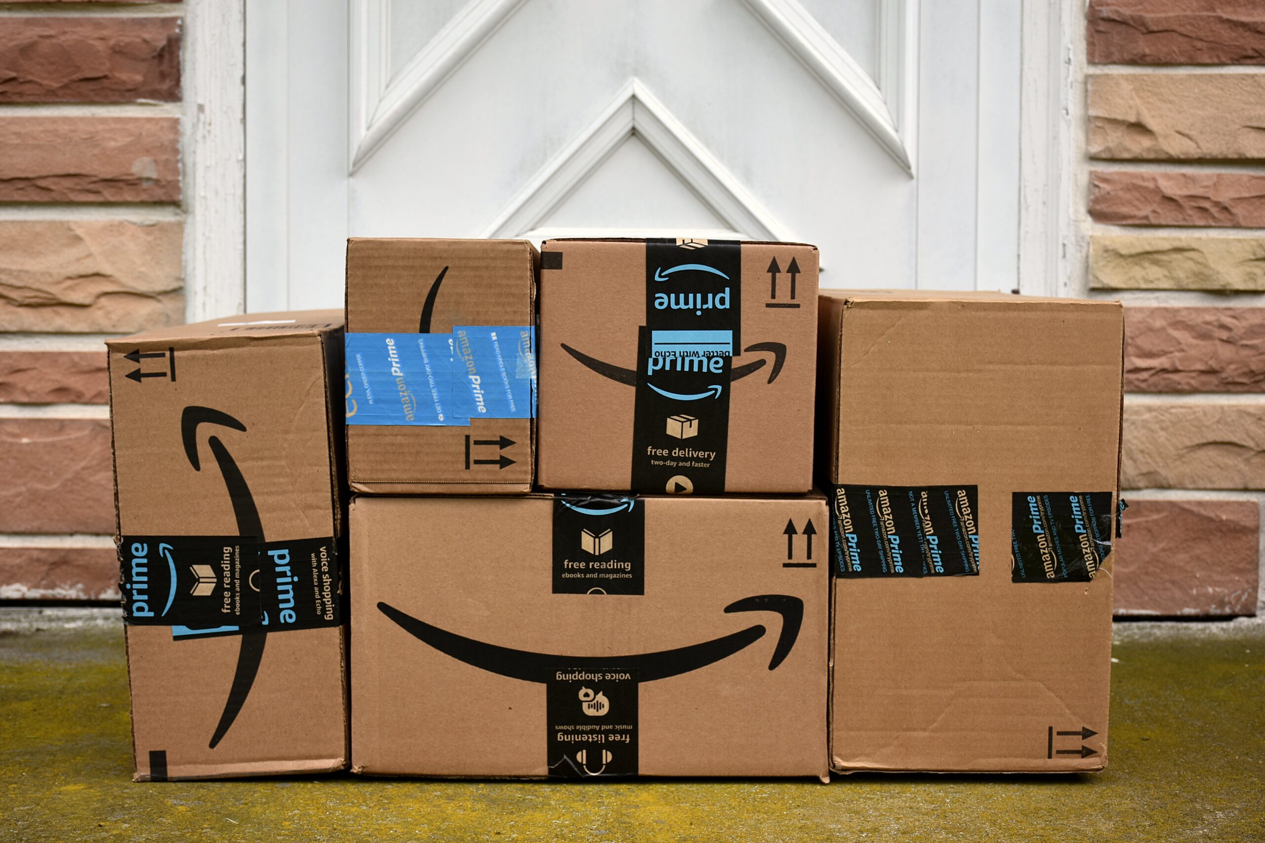 Amazon packages stacked up on front porch
