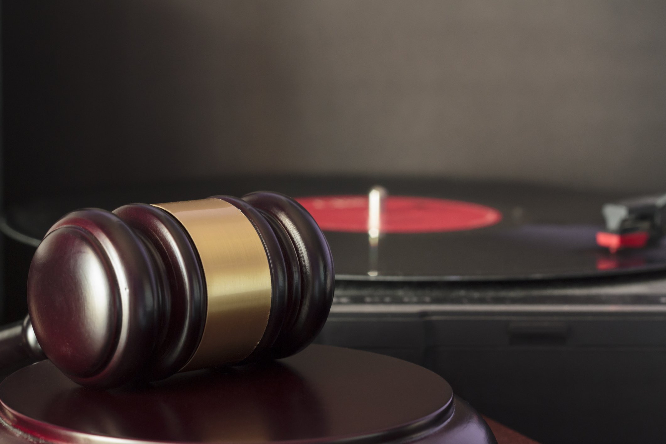 Judge's gavel in front of a vinyl record