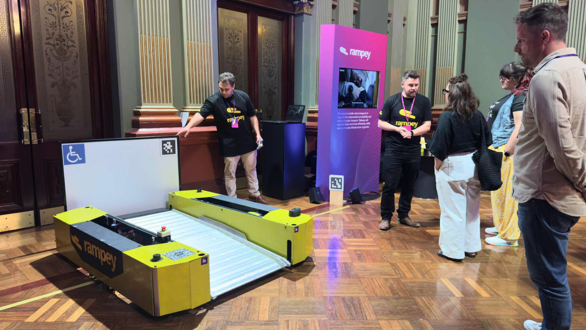 Rampey's booth at Remarkable's 2025 Disability Tech Summit, featuring a robot ramp.