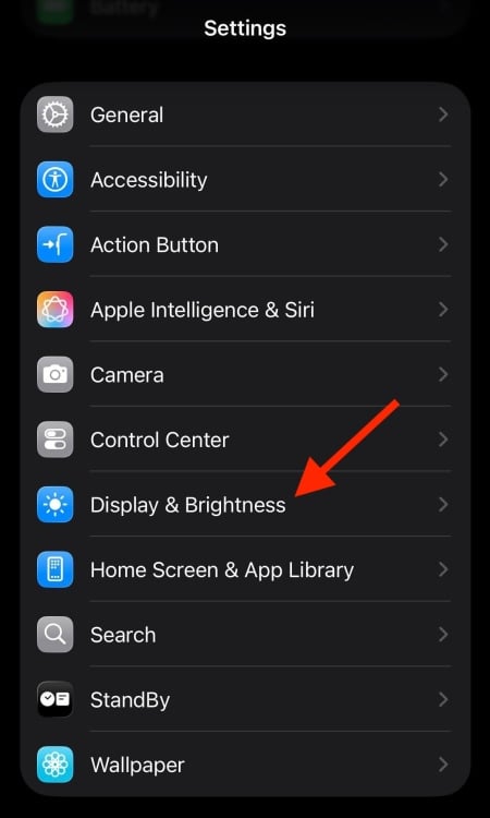 iOS settings app with a red arrow pointing to Display & Brightness