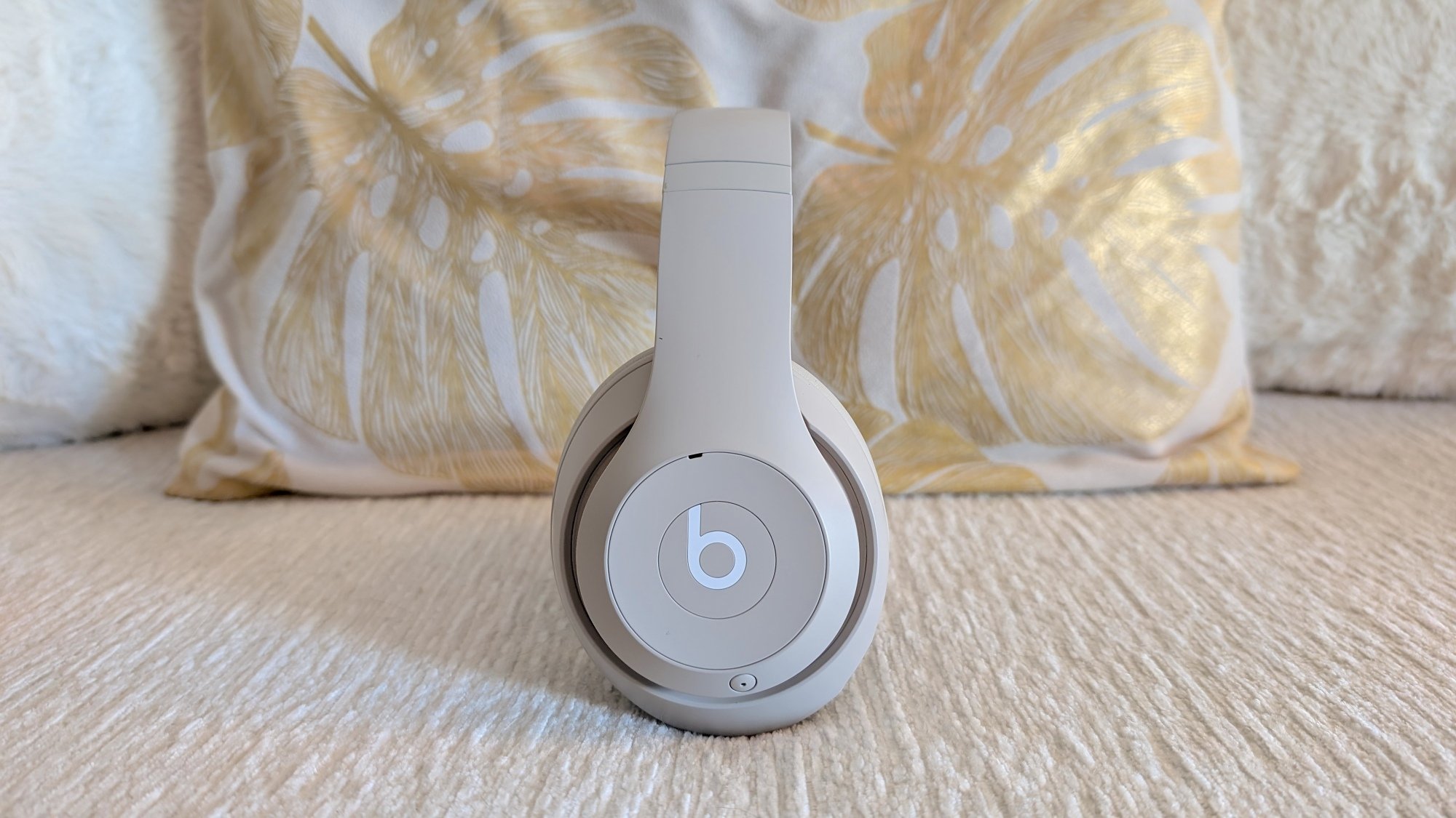 cream colored beats studio pro balanced on couch