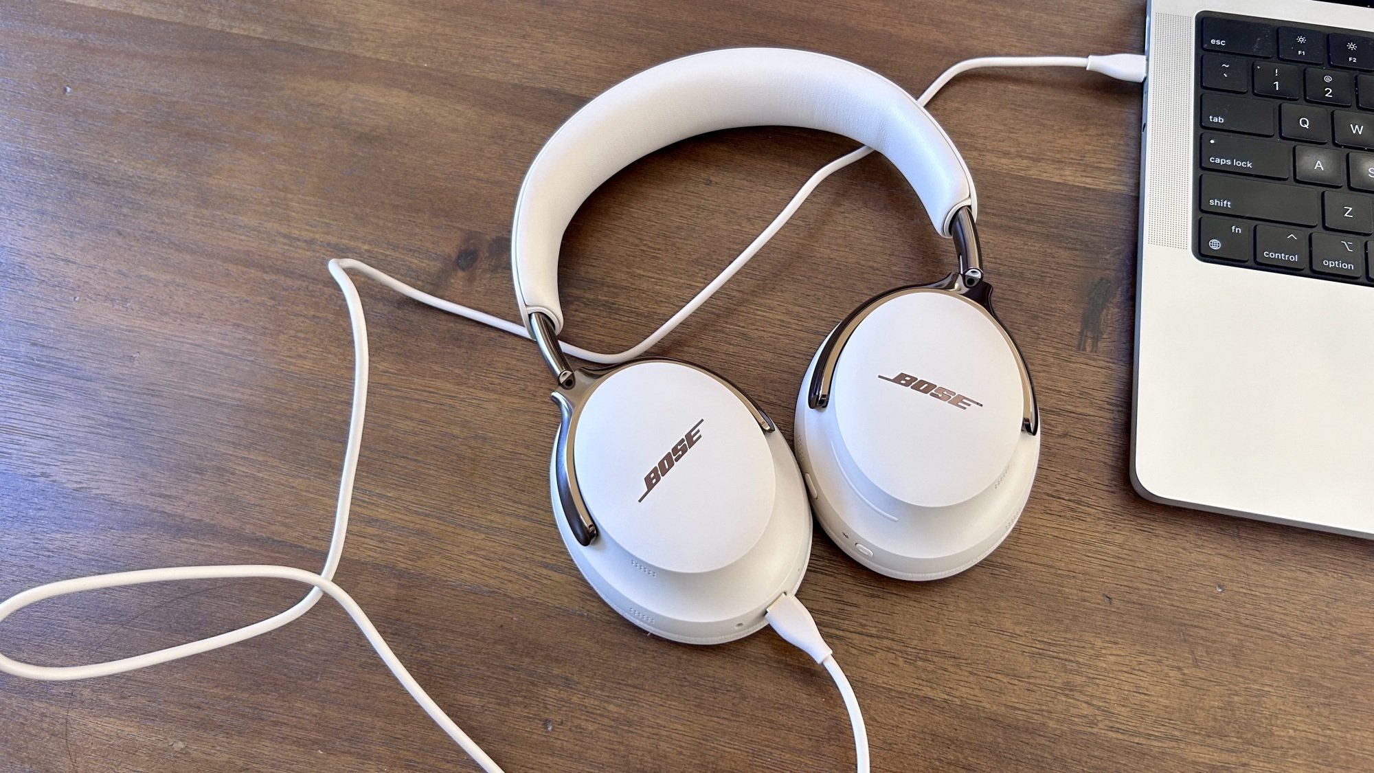 bose qc ultra headphones connected to laptop via usb-c cable