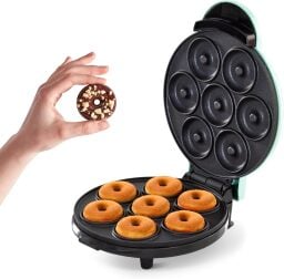 Dash mini donut maker open and hand holding donut