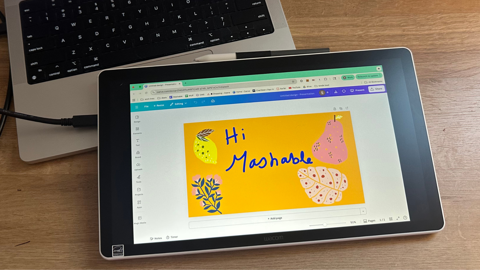 A Wacom One 14 tablet on top of a laptop keyboard.