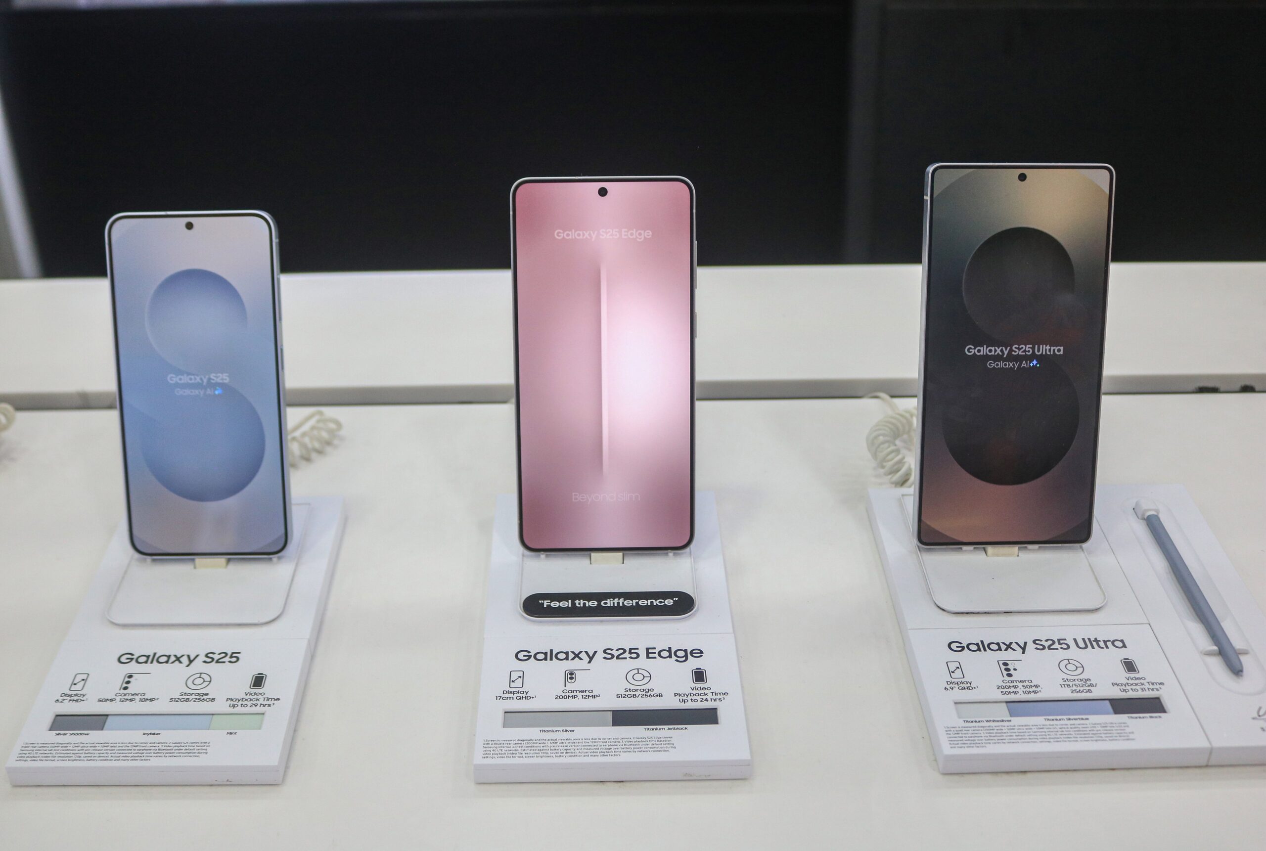 Samsung Galaxy S25 (left), Samsung Galaxy S25 Edge (center), and Samsung Galaxy S25 Ultra (right) smart mobile phones are displayed for sale at a mobile store