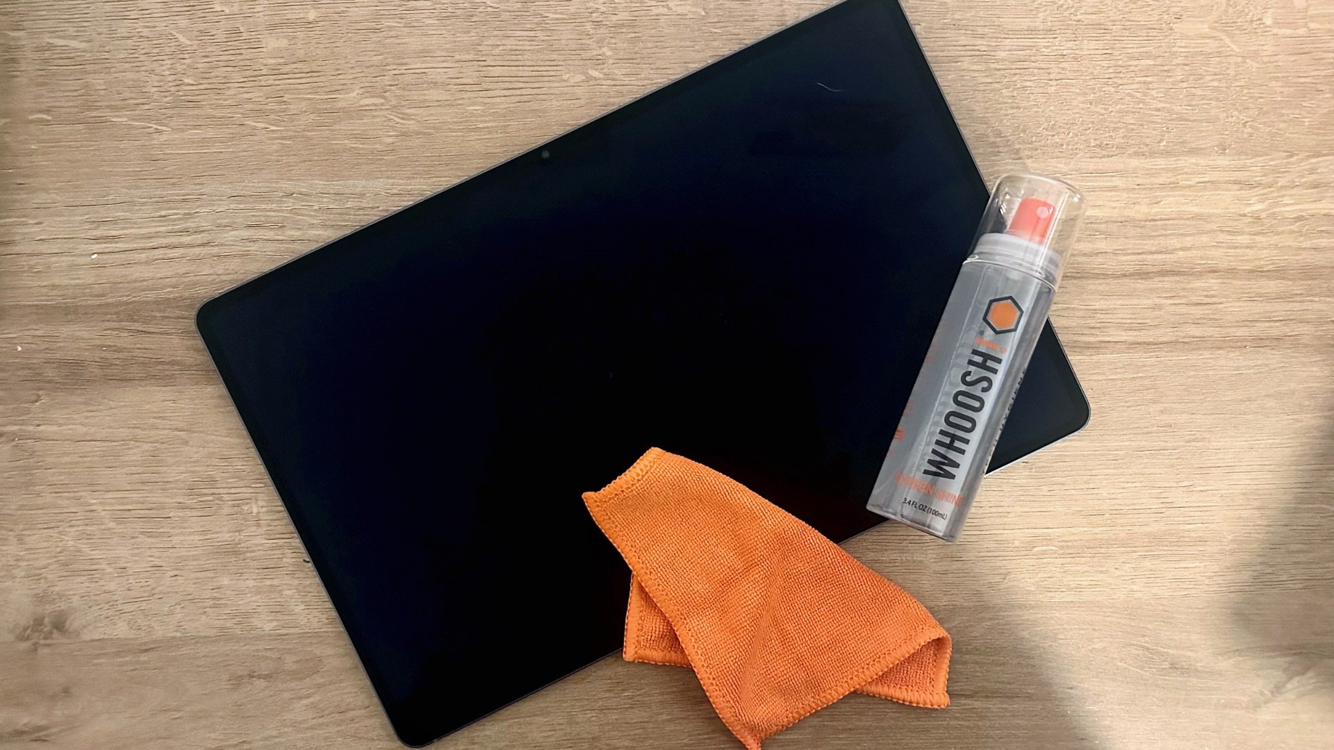 a bottle of whoosh screen cleaner on a tablet