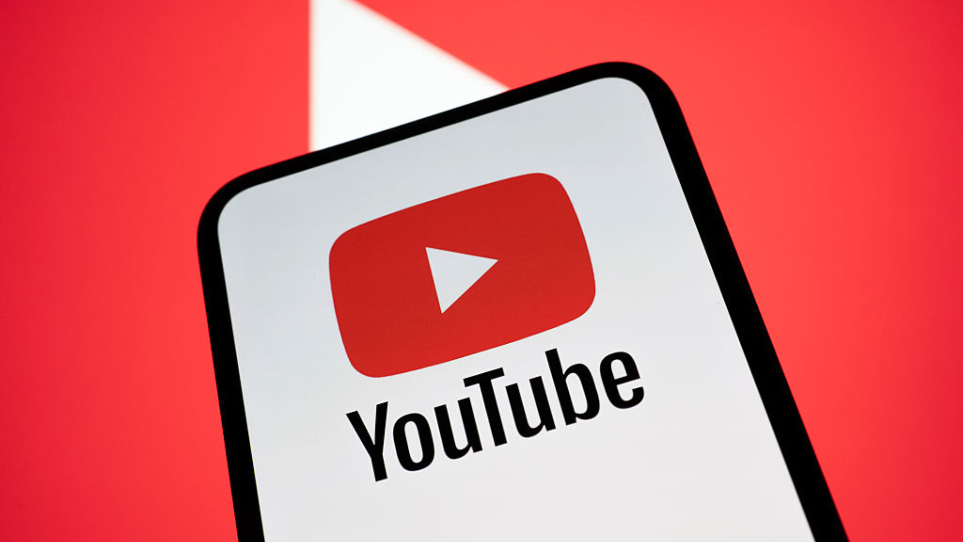 The YouTube logo appears on a smartphone screen with the YouTube logo in the background.