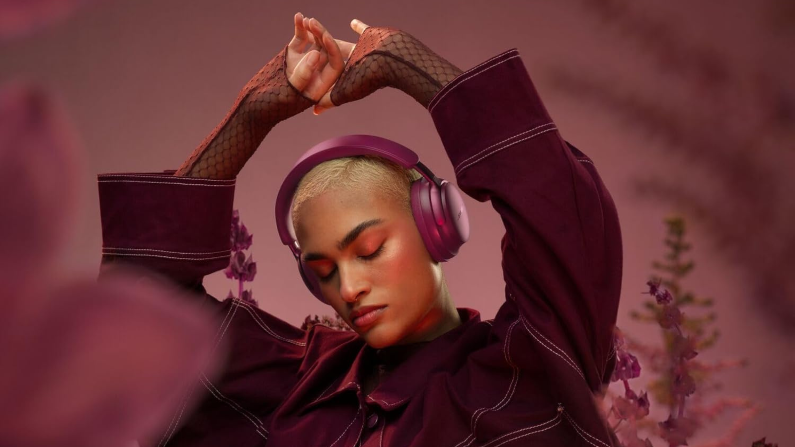 woman dancing and wearing Bose QuietComfort Ultra headphones in deep plum