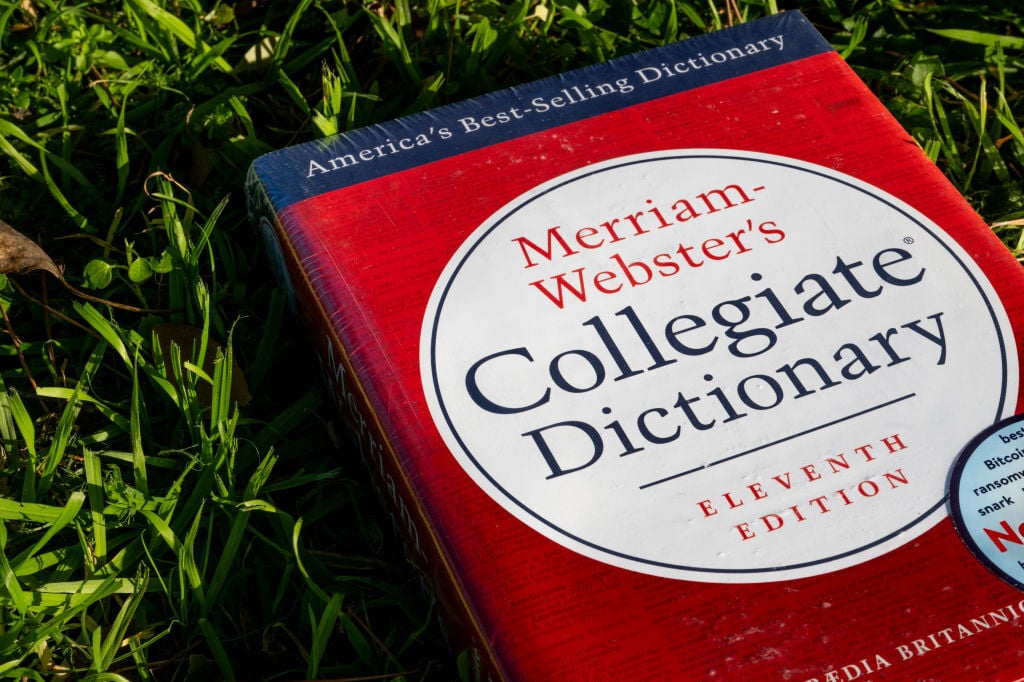 Merriam-Webster dictionary in a field of grass
