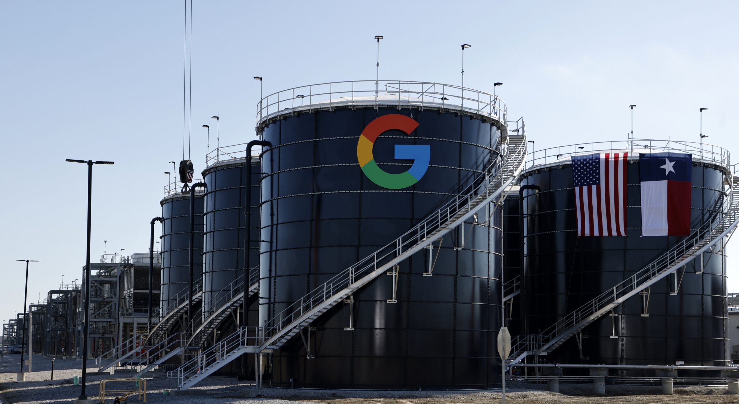 Two large metal structures emblazoned with the Google logo and the Texas state flag.
