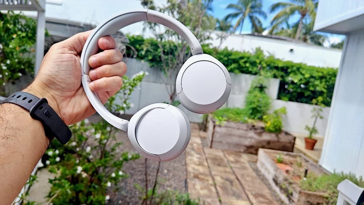 hand holding the sony wh-ch520 headphones outside