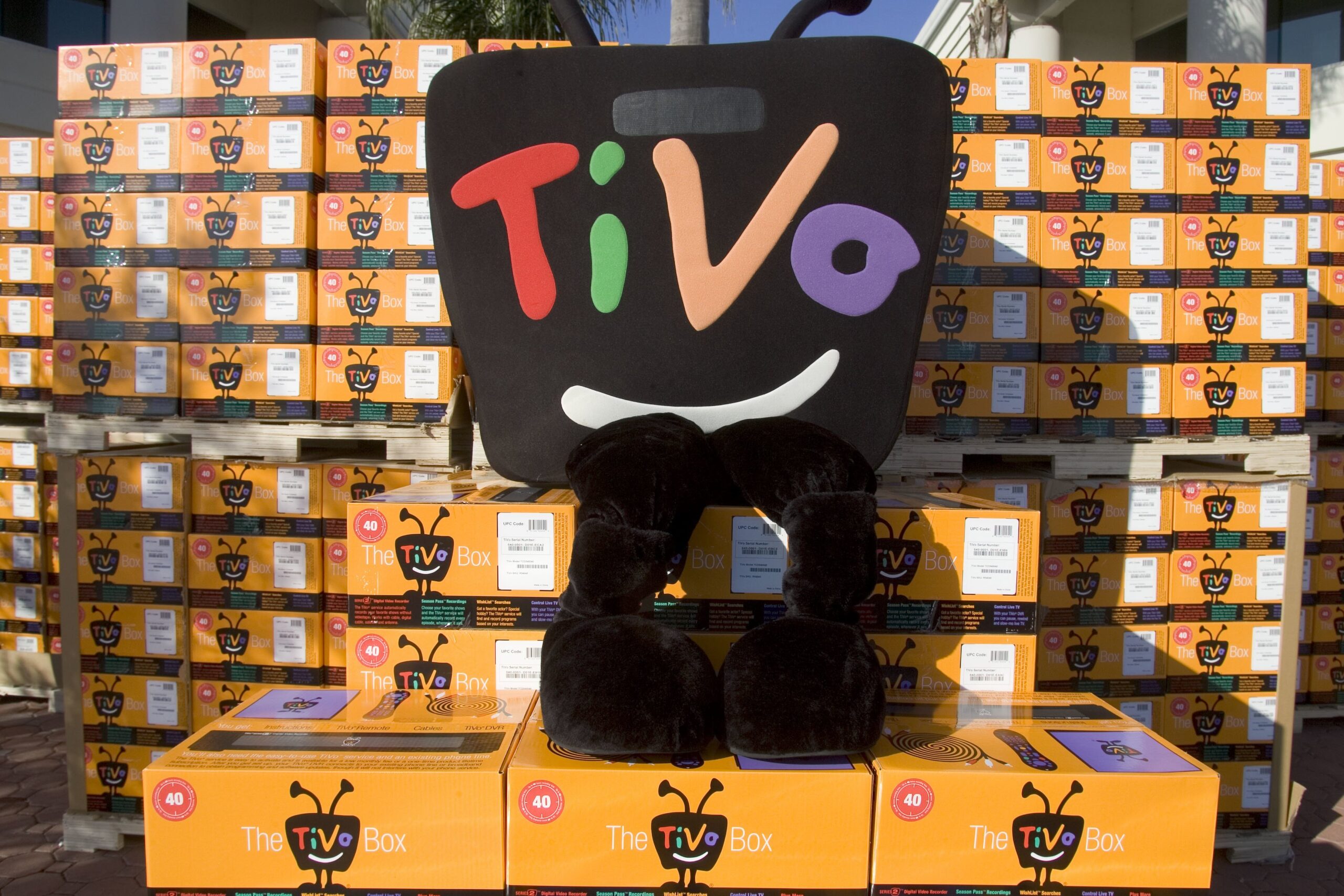 a tivo character standing on tivo boxes