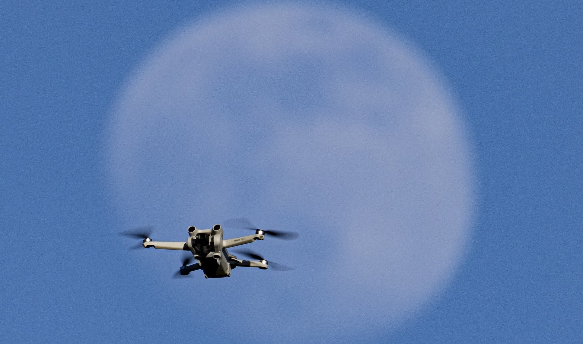 A drone in front of the moon