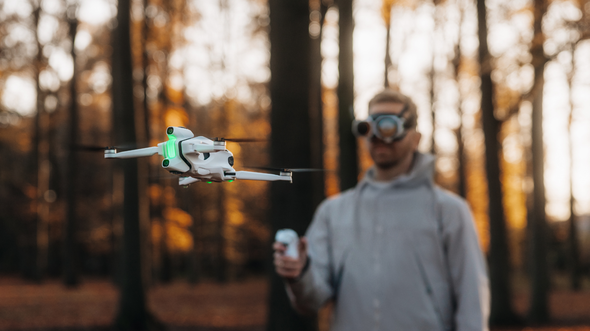 A man piloting the Antigravity A1 drone, wearing the Vision goggles and using the Grip controller.