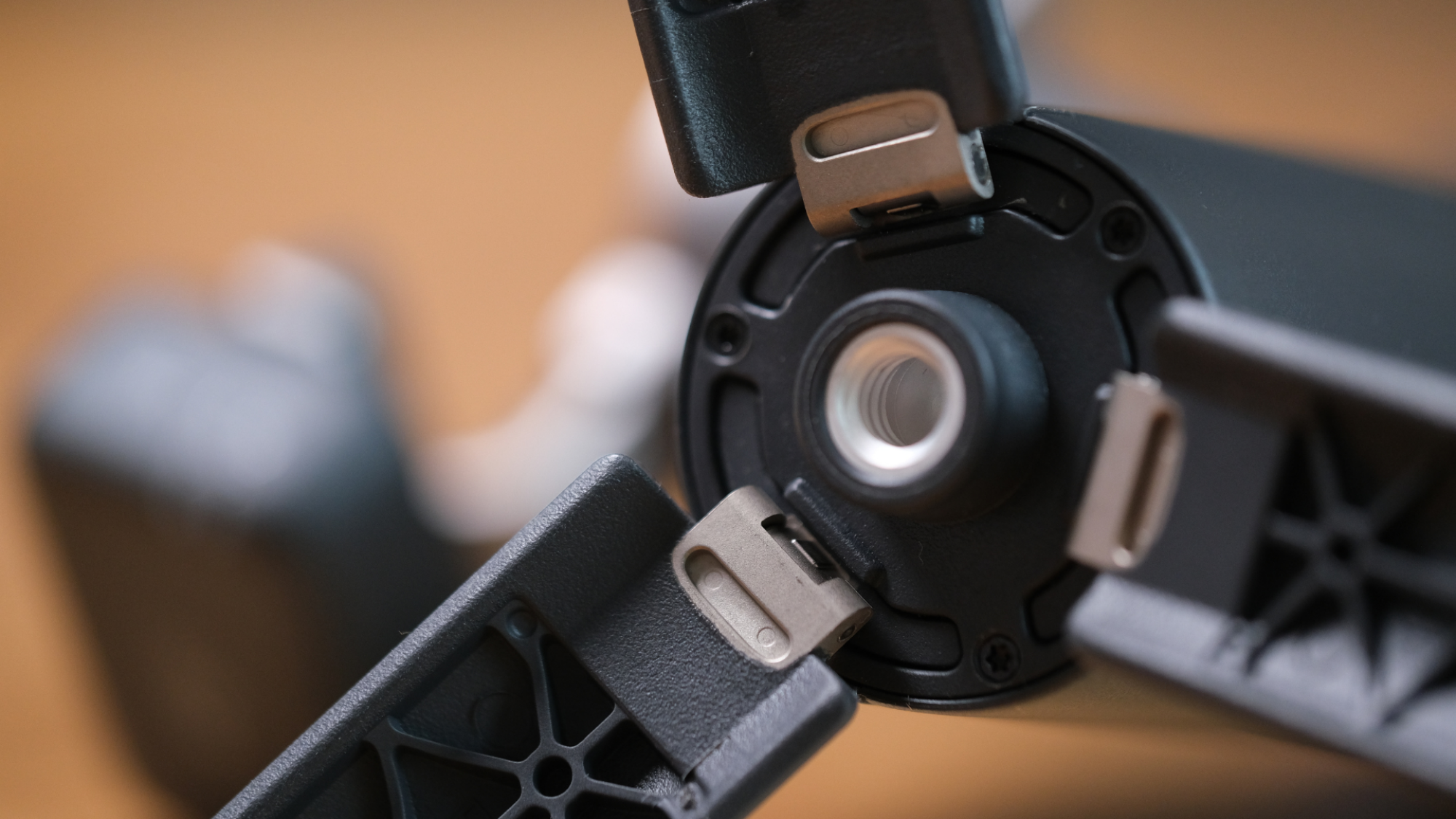 The underside of the DJI Osmo Mobile 8 with the tripod deployed, showing a mounting thread.
