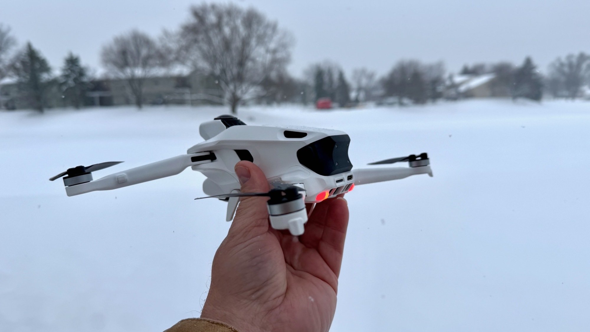 holding antigravity a1 drone in snowy field
