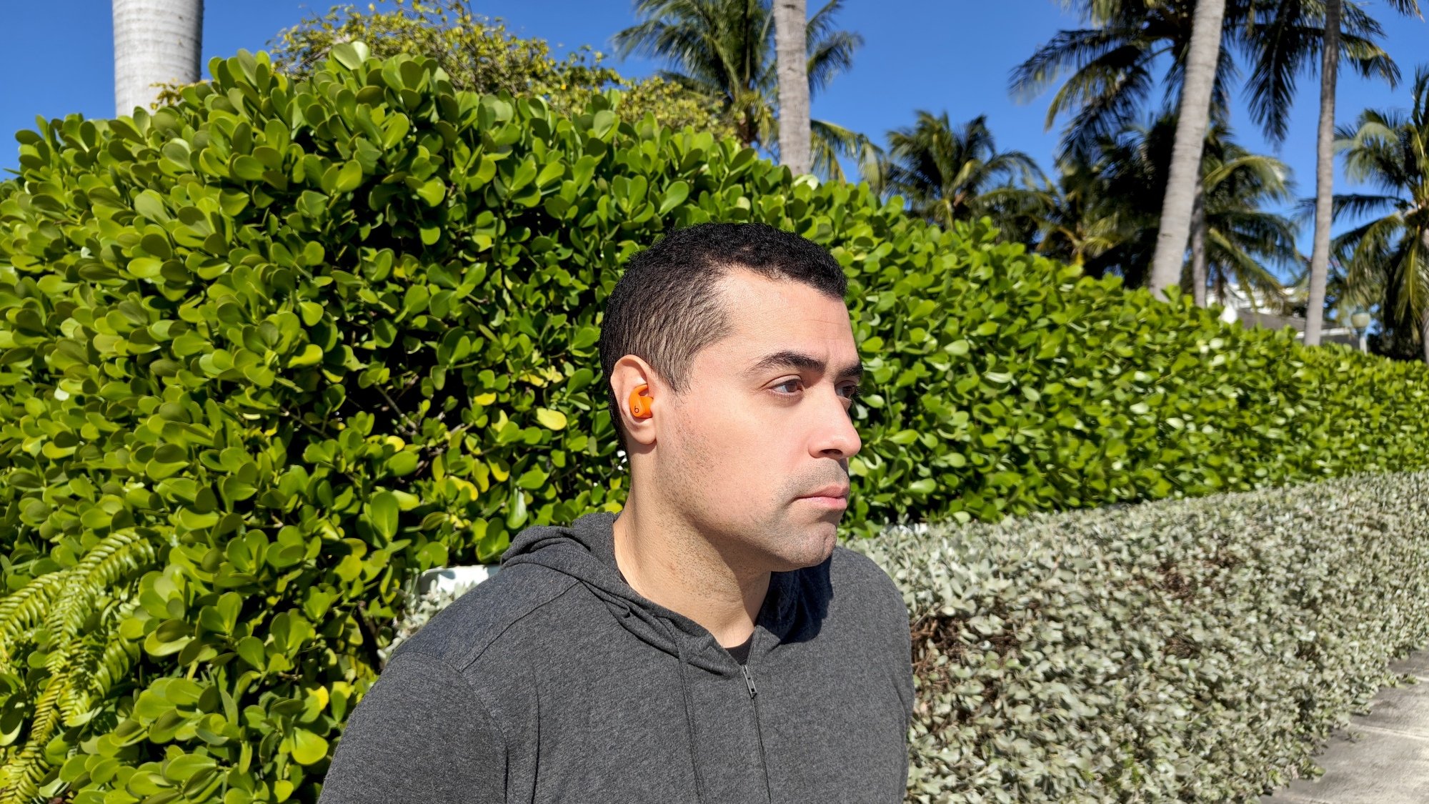 the author wearing the powerbeats fit earbuds outdoors