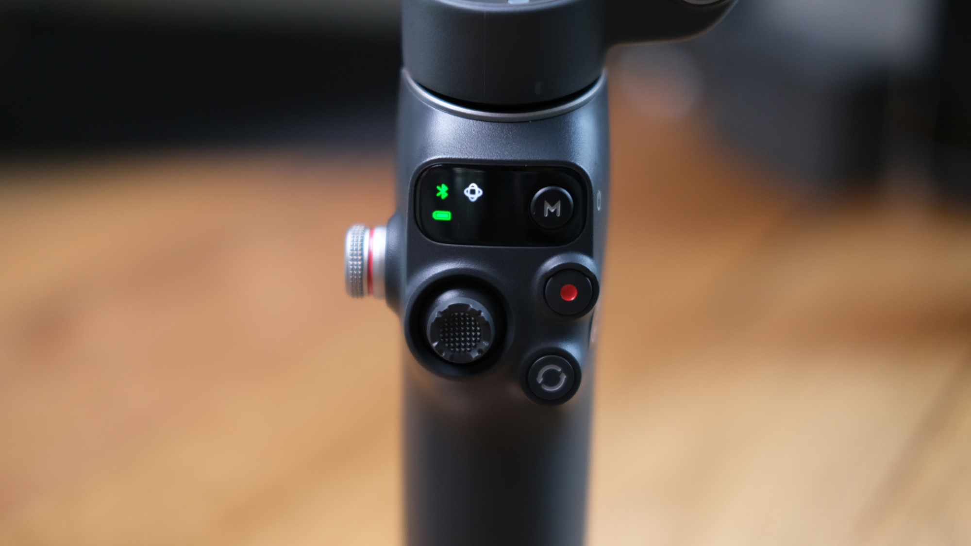 The buttons on the DJI Osmo Mobile 8.