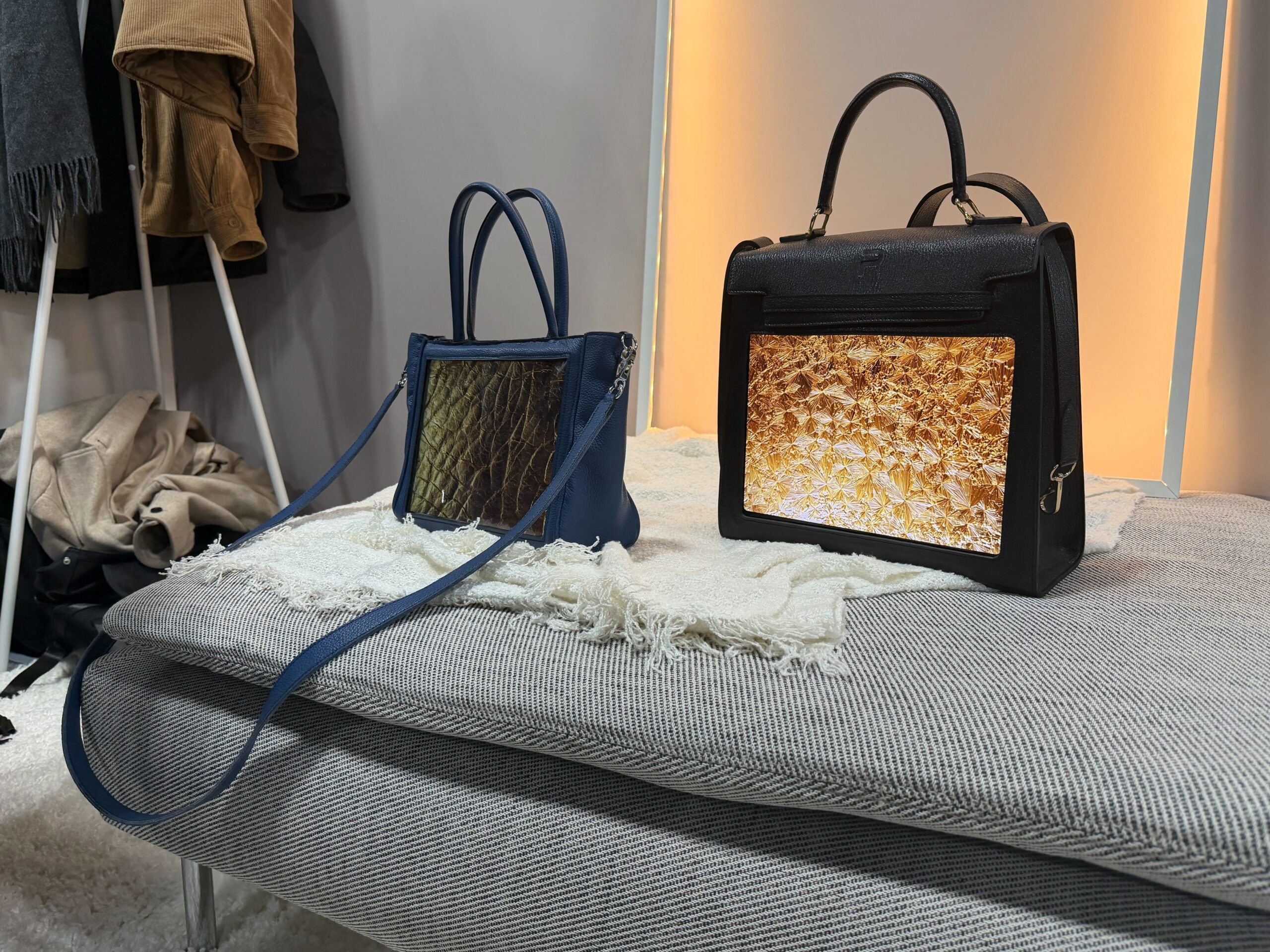 two smart oled handbags standing side by side in blue and black