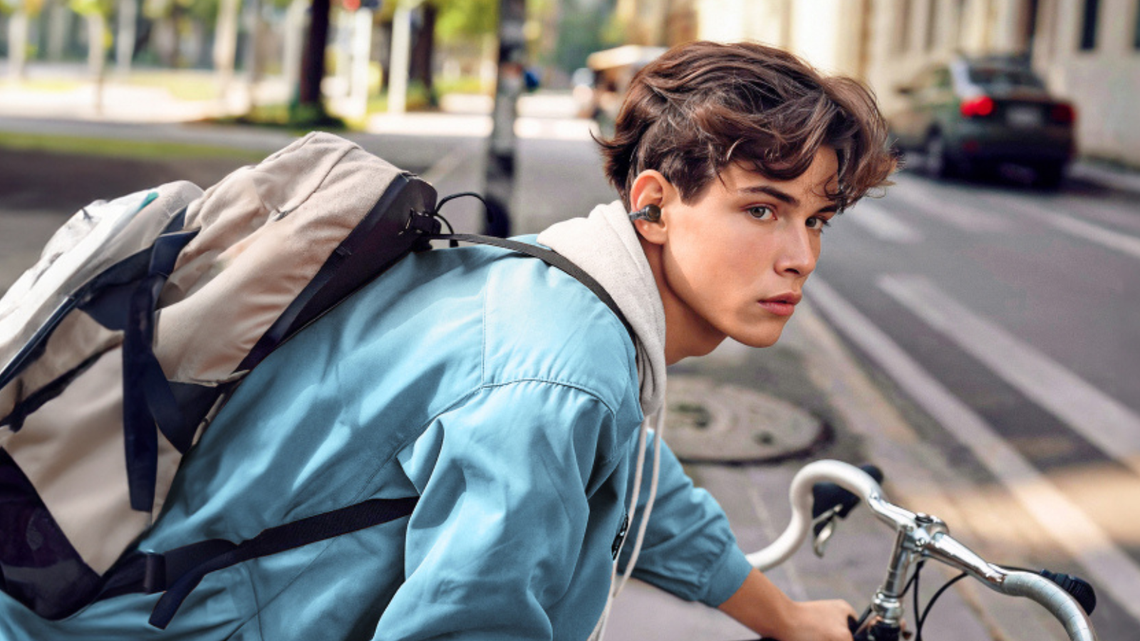 man riding bike wearing Soundcore C30i open earbuds