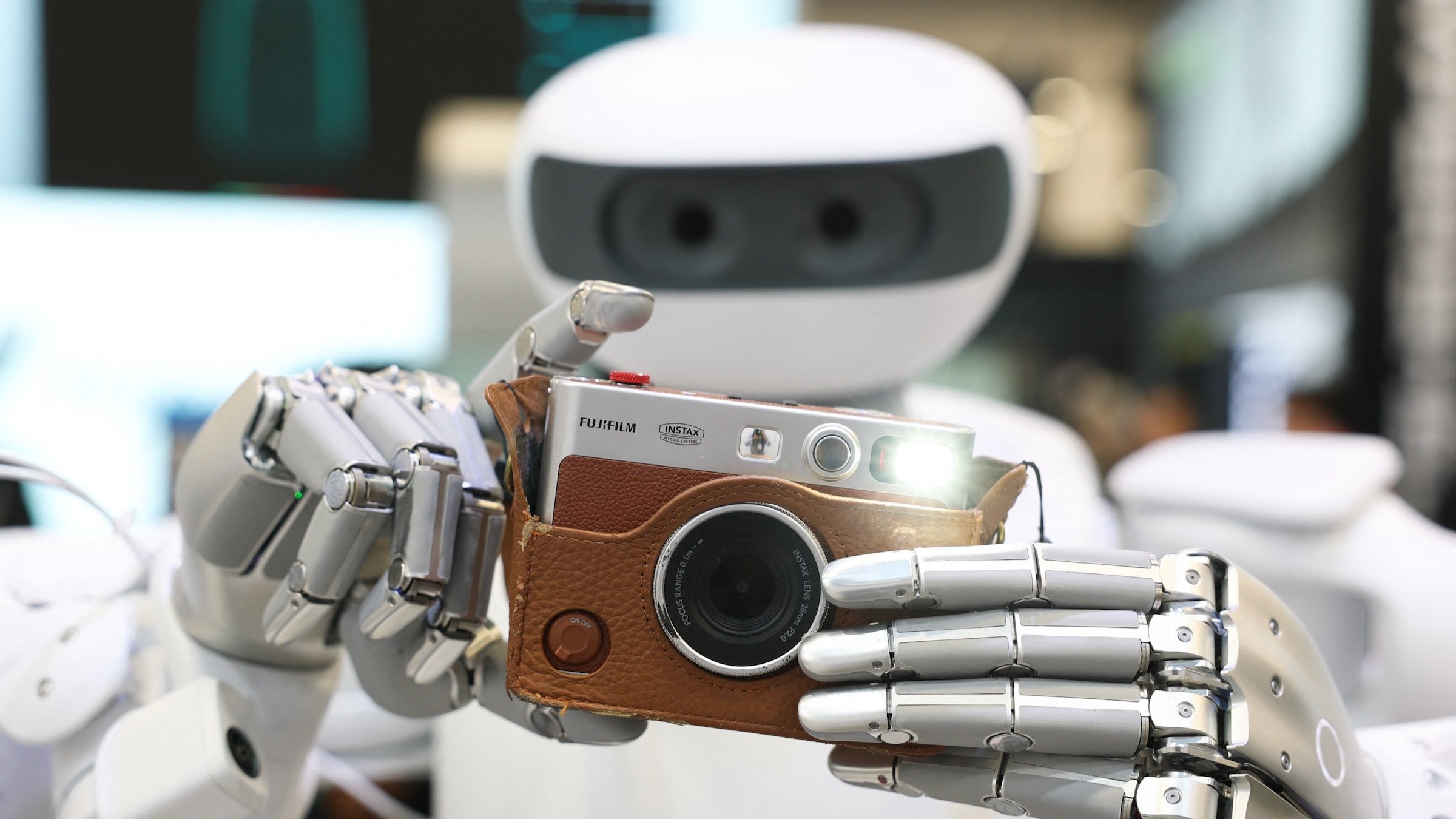  Sharpa robot takes a photograph with a Fujifilm instax camera during the annual Consumer Electronics Show (CES) in Las Vegas