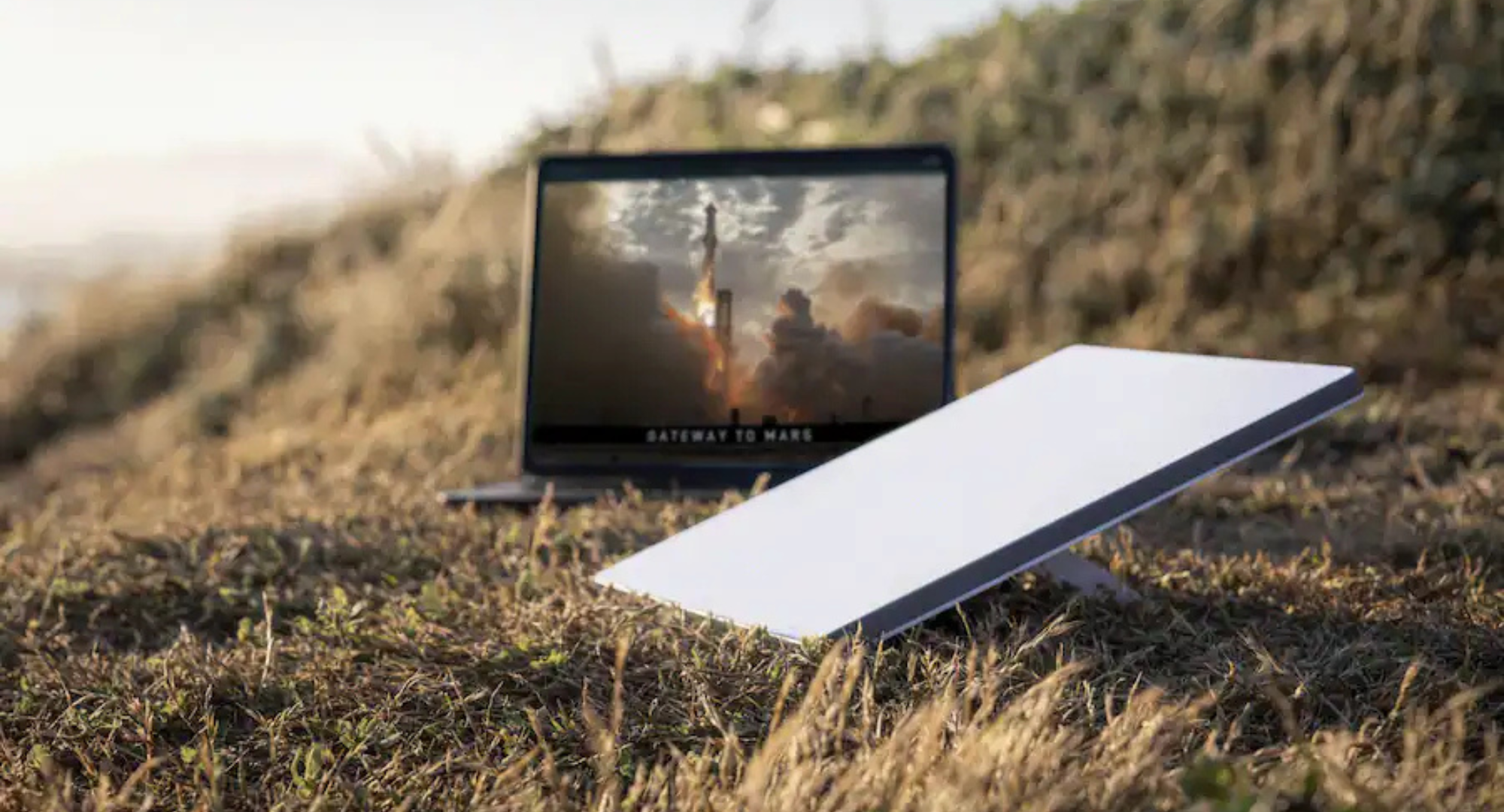 A lifestyle image of the Mini Kit AC Dual Band Wi-Fi System sitting on the grass. 