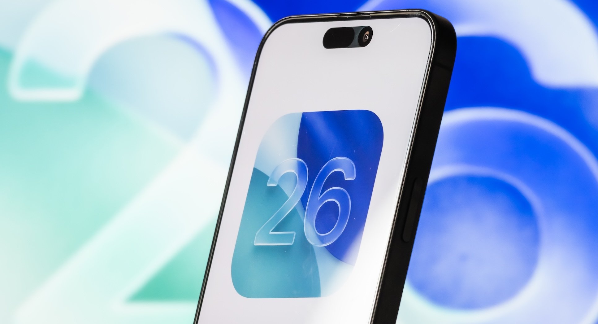 An iPhone with the iOS 26 logo