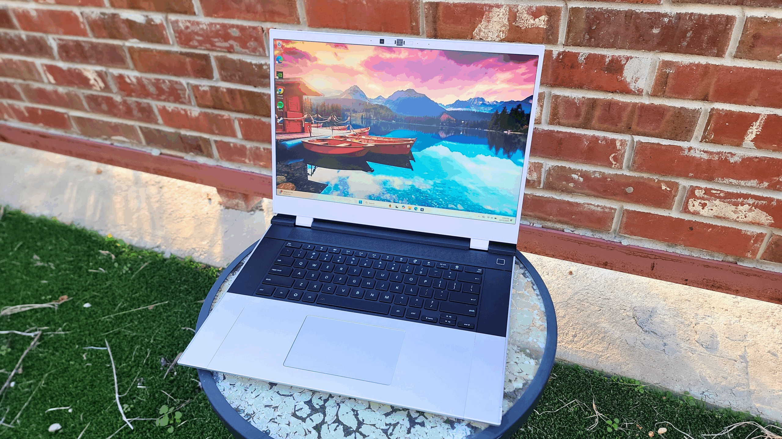 framework 16 laptop outside against a brick wall