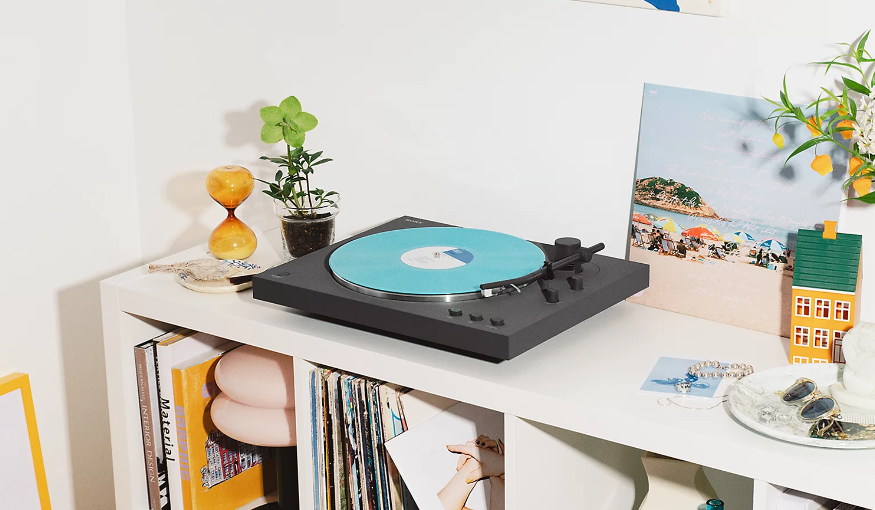 Sony PS-LX3BT Bluetooth turntable spinning turquoise record on shelf