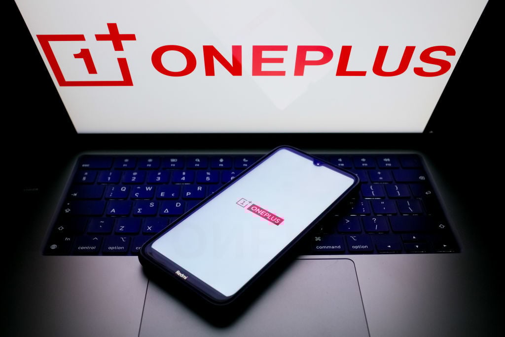 OnePlus logo on laptop and smartphone screens