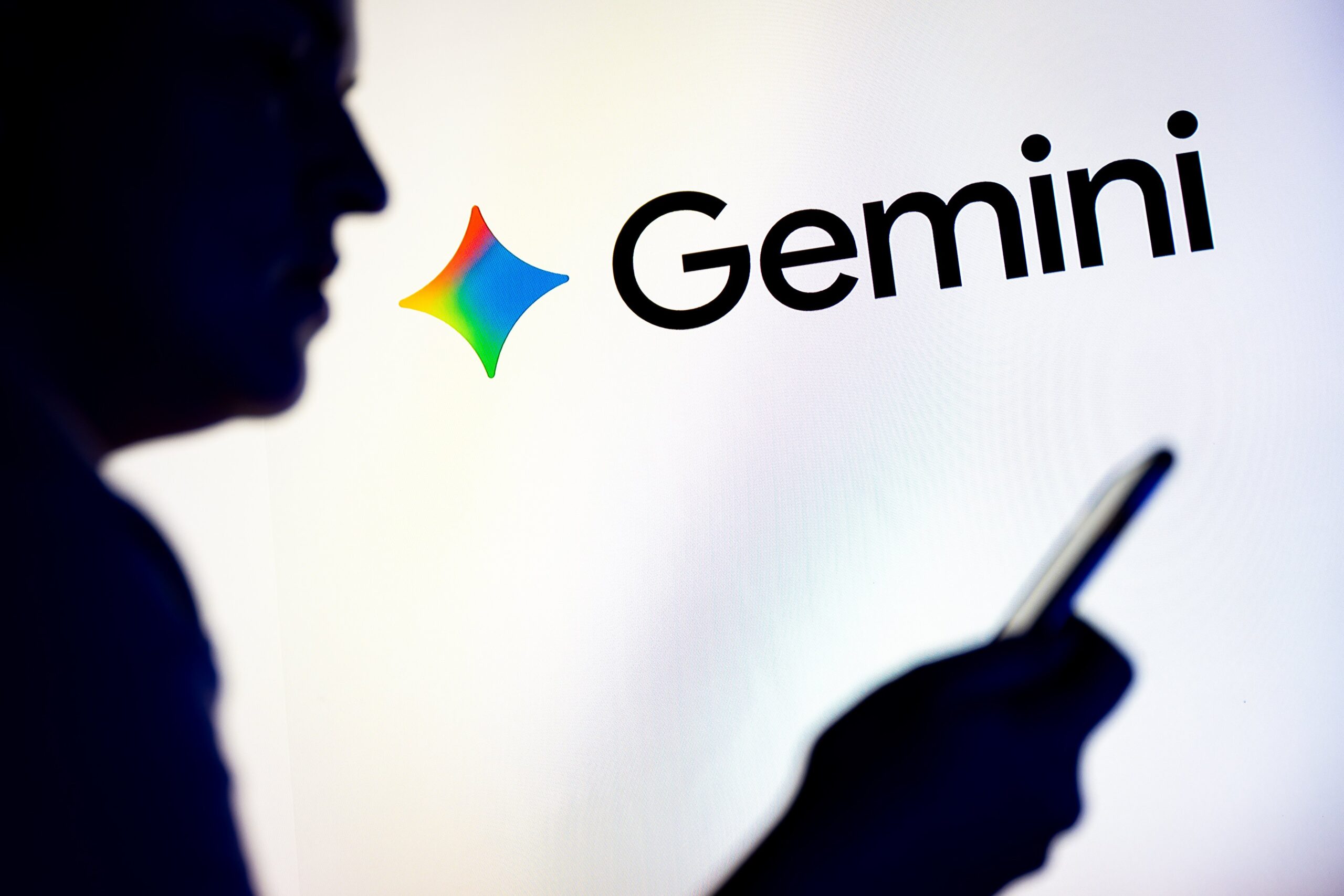 Google Gemini logo next to a man on a mobile device