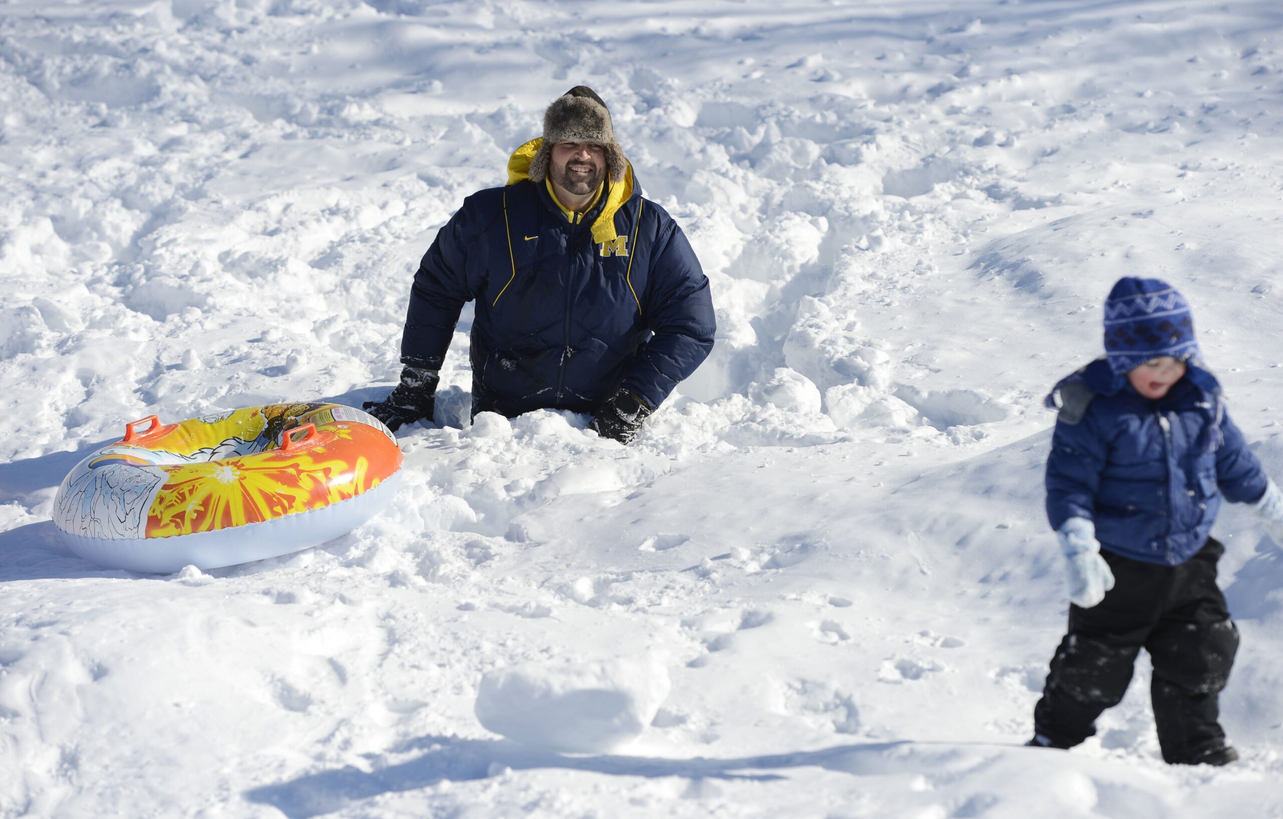 A man up to his waist in snow
