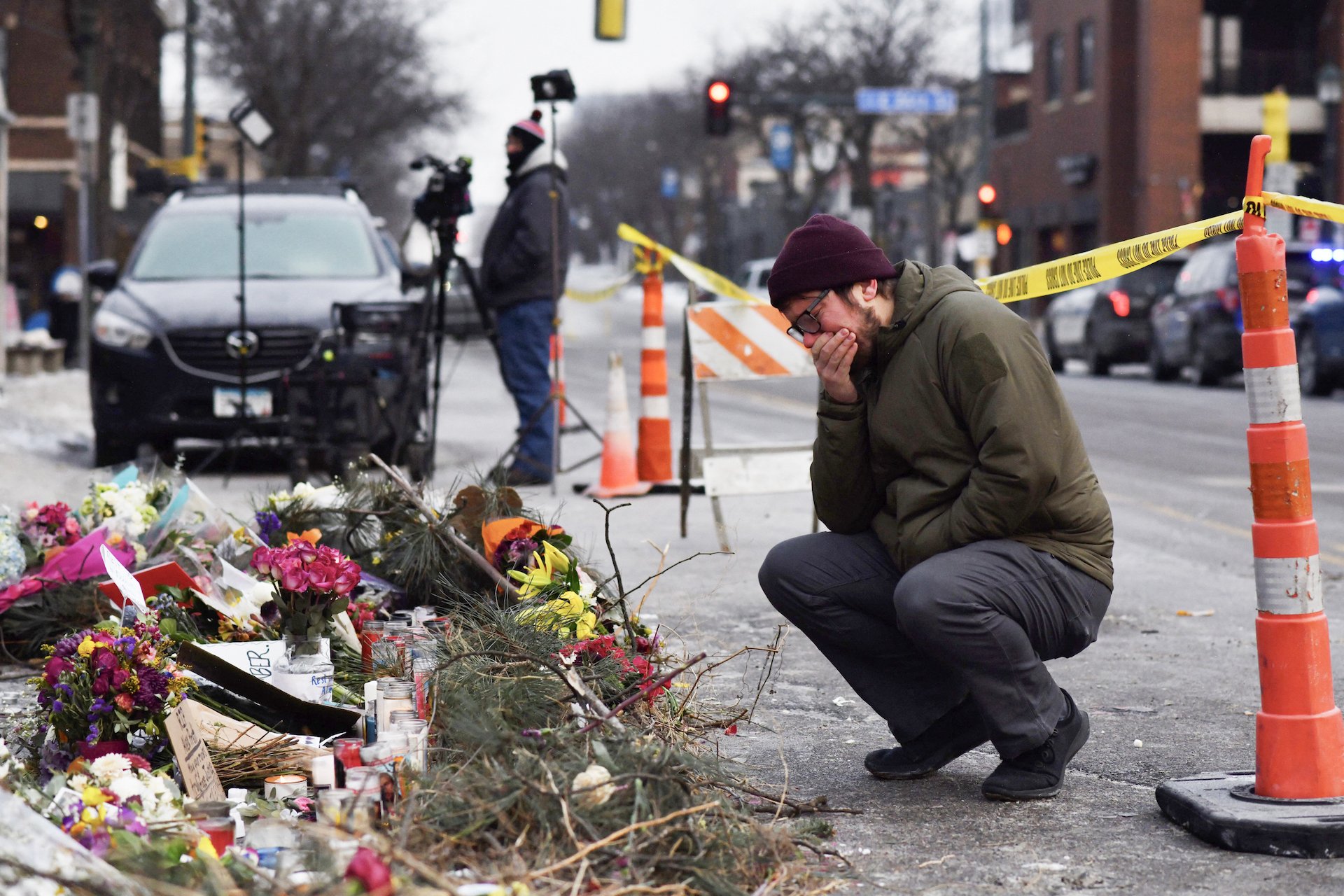 A mourner cries at a makeshift memorial for ICE shooting victim Alex Pretti, 