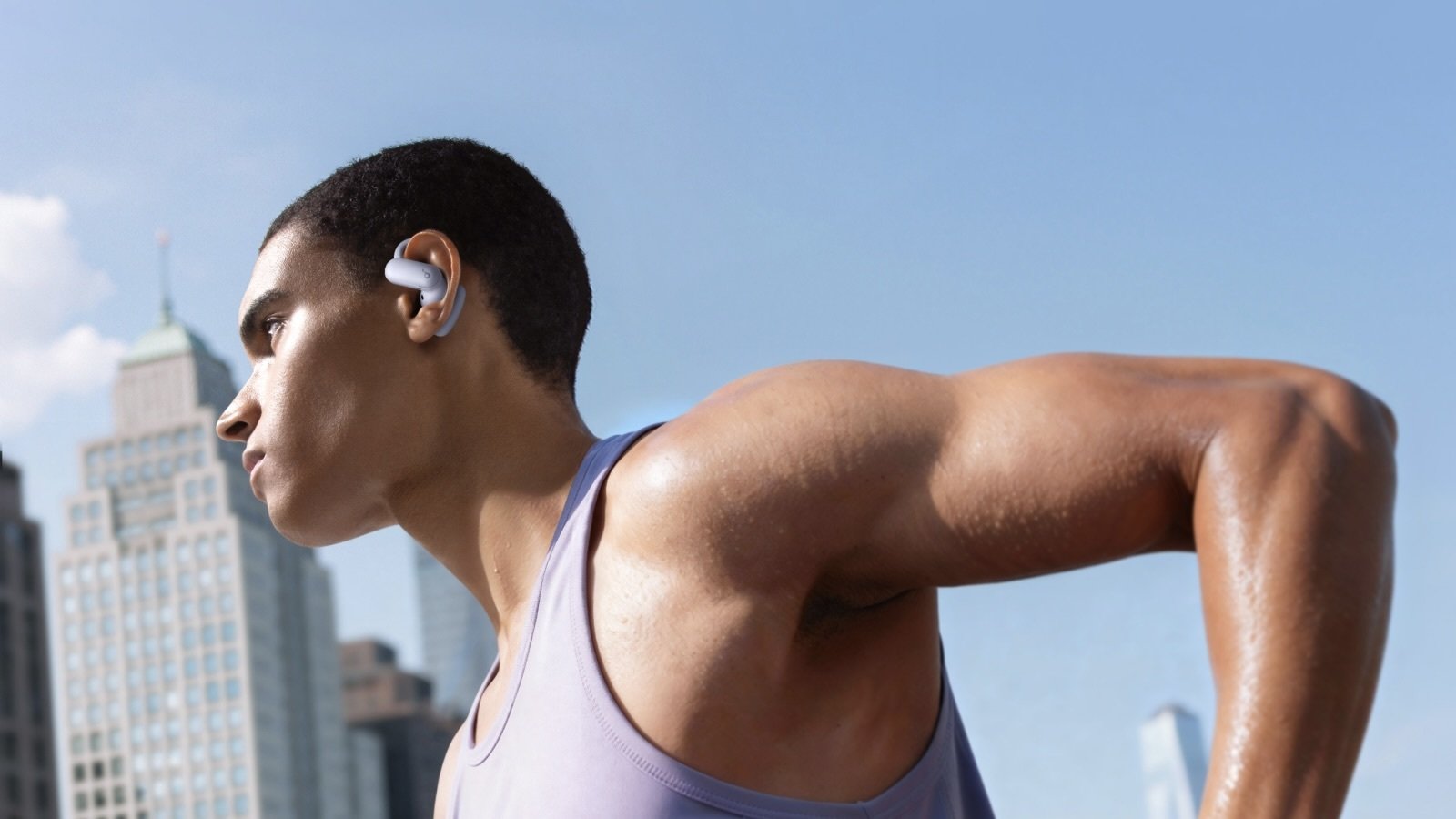 person running outside wearing ear hook earbuds