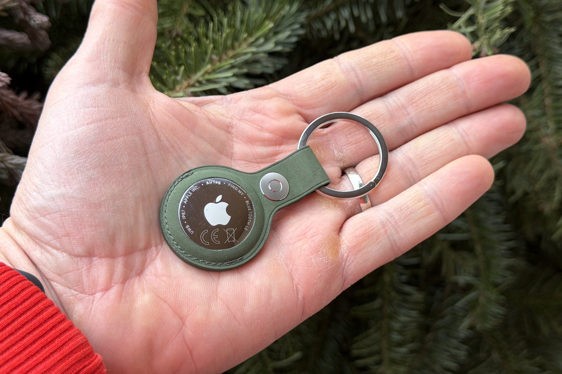 close-up of new apple airtag in man's hand