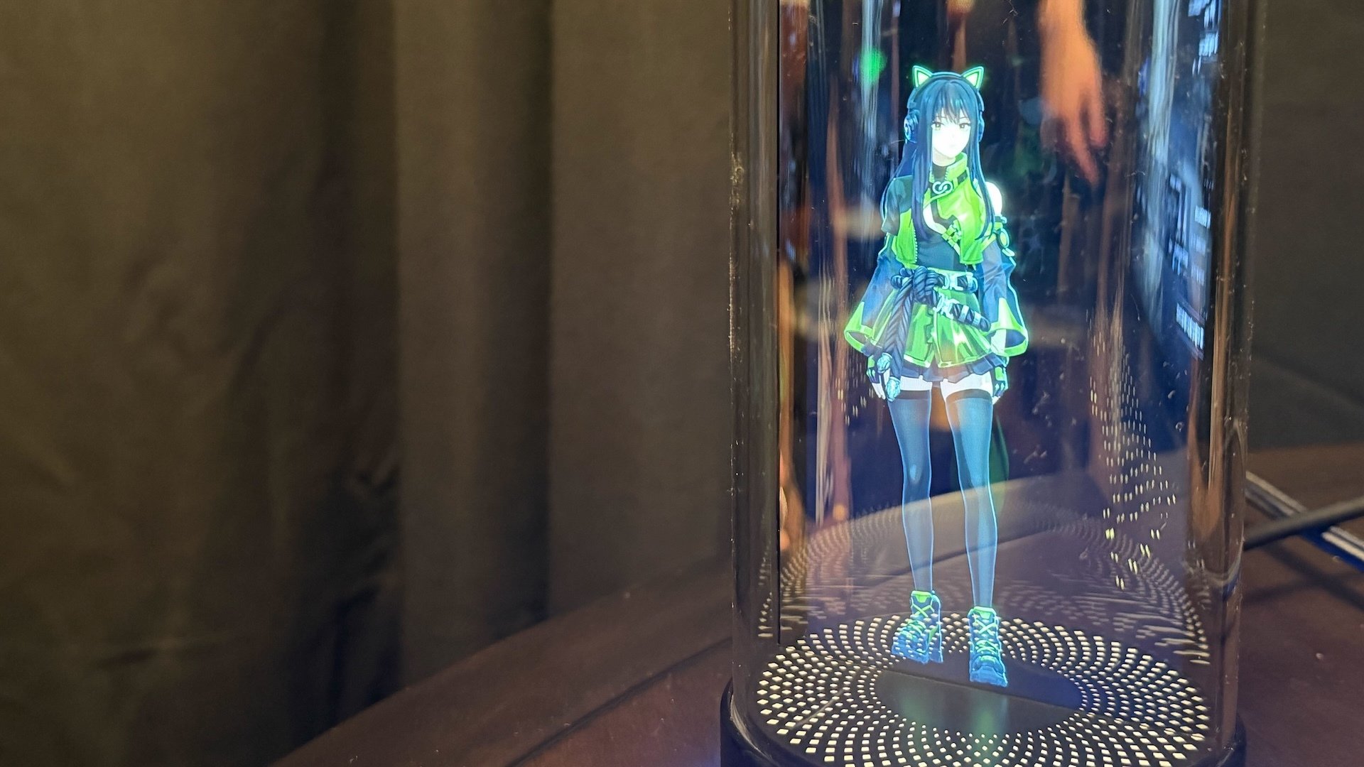 Holodeck device with generated gamer girl in green blouse and skirt