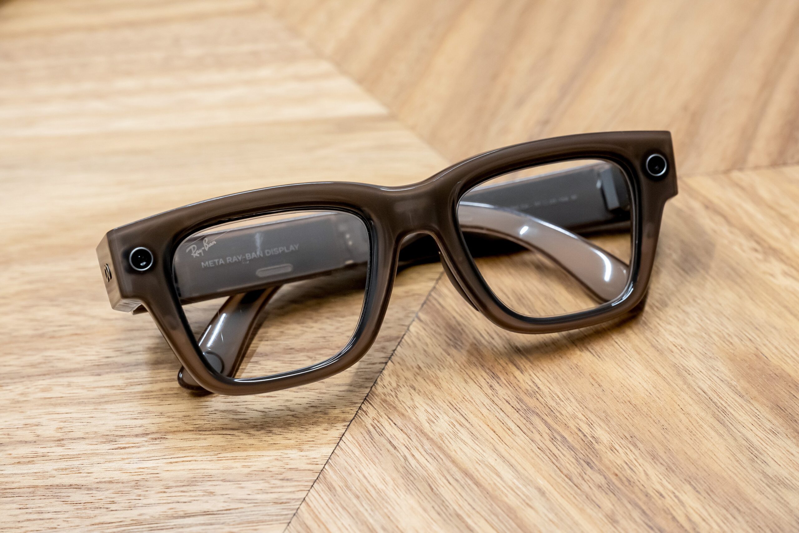 meta ray ban display glasses on wood counter top