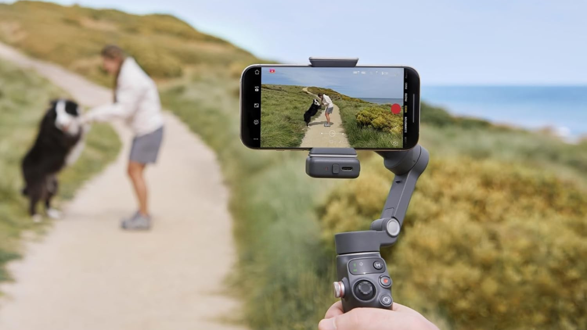 A person using the DJI Osmo Mobile 7P to film on their iPhone