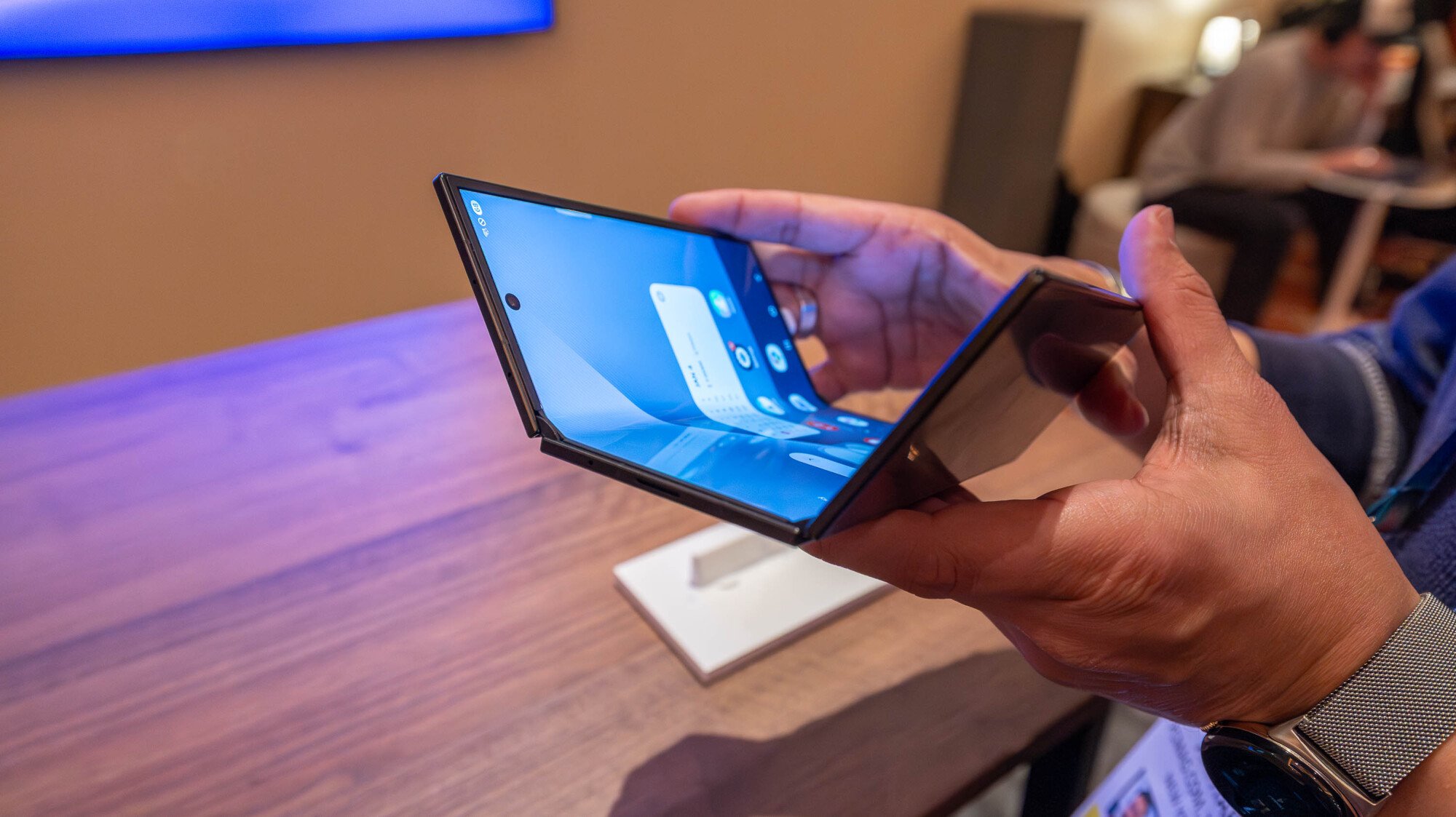 Samsung TriFold being partially folded on display