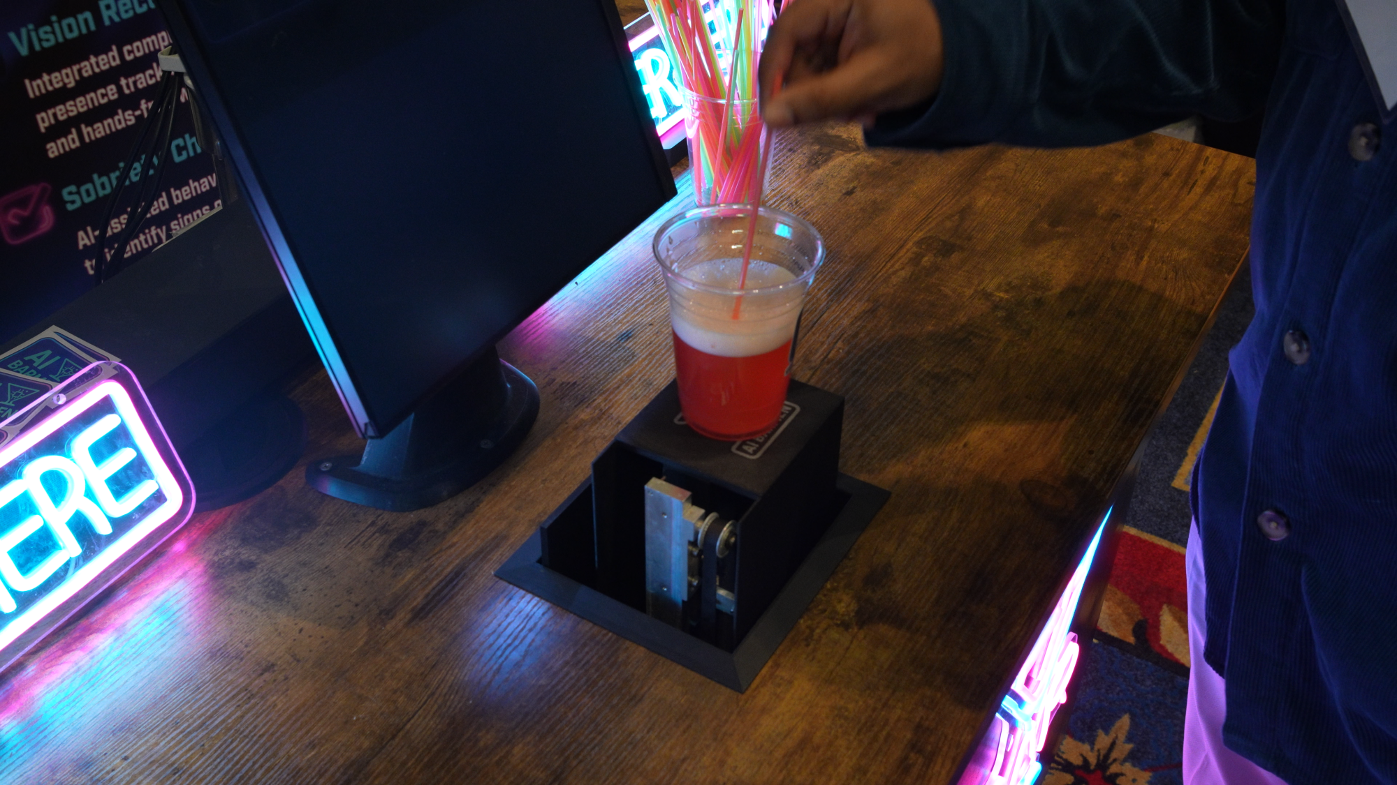 A bar chart unveils a pink drink made by an AI bartender