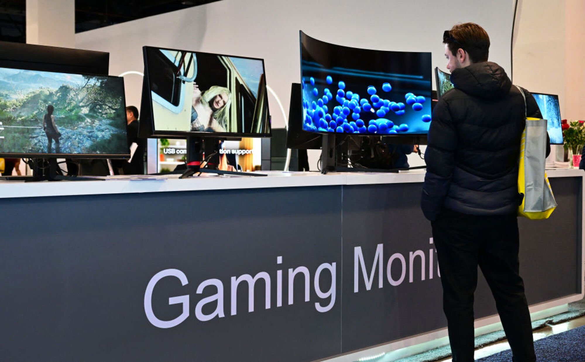 Man looking at gaming monitors at CES 2024.
