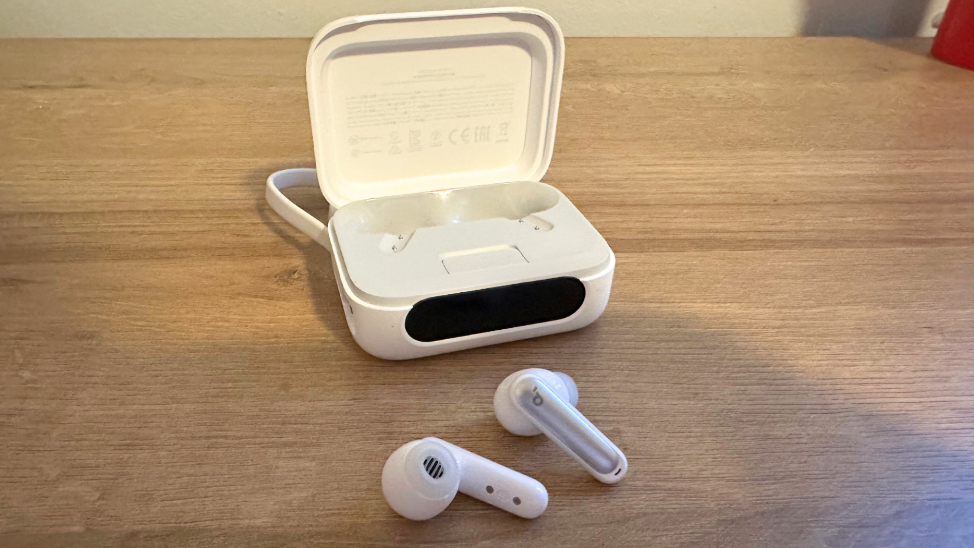 A pair of Soundcore P41i earbuds on a table