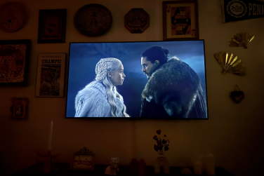 'Game of Thrones' scene on wall-mounted TV in dark room