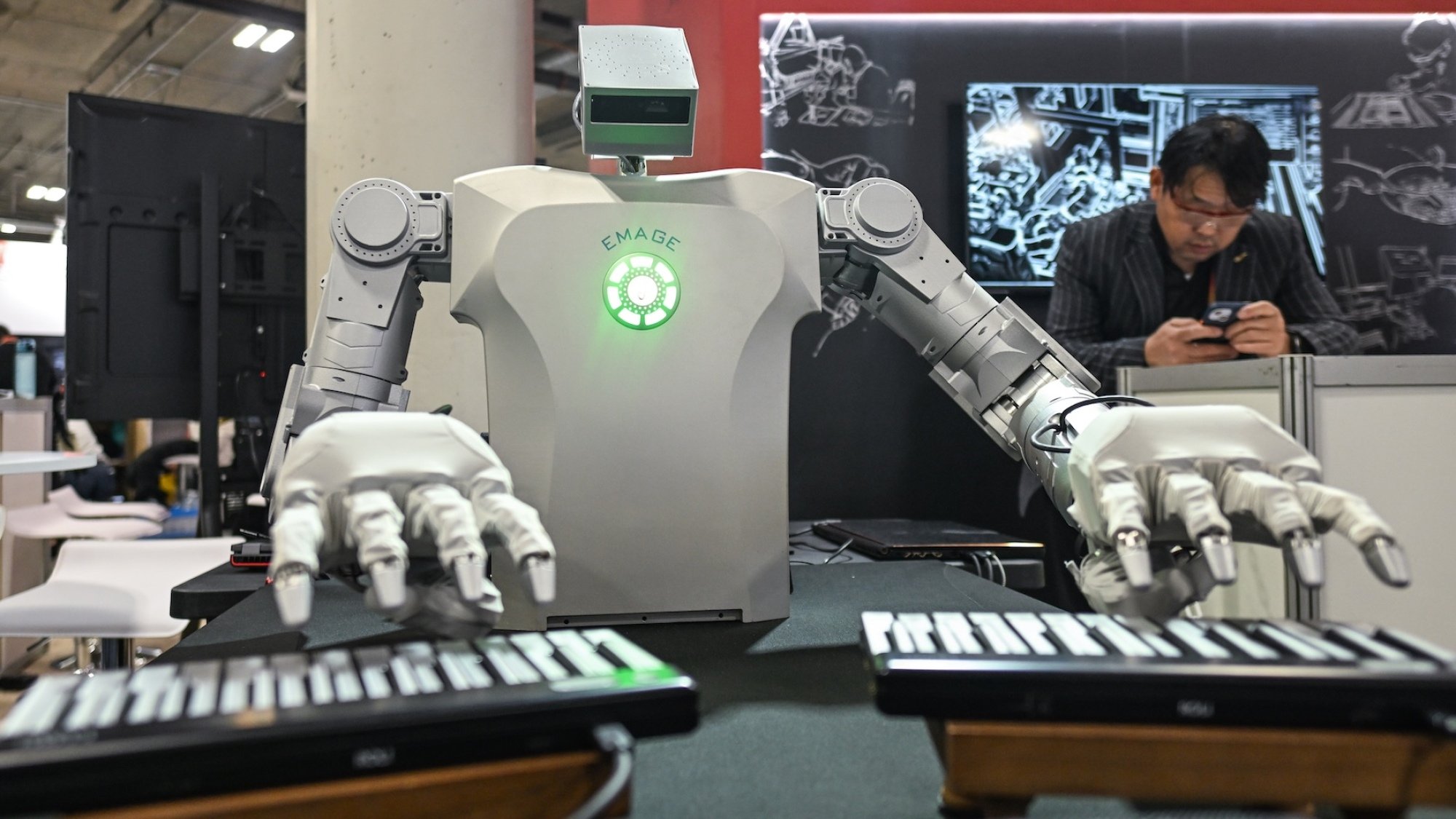 A robot playing two synthesizers