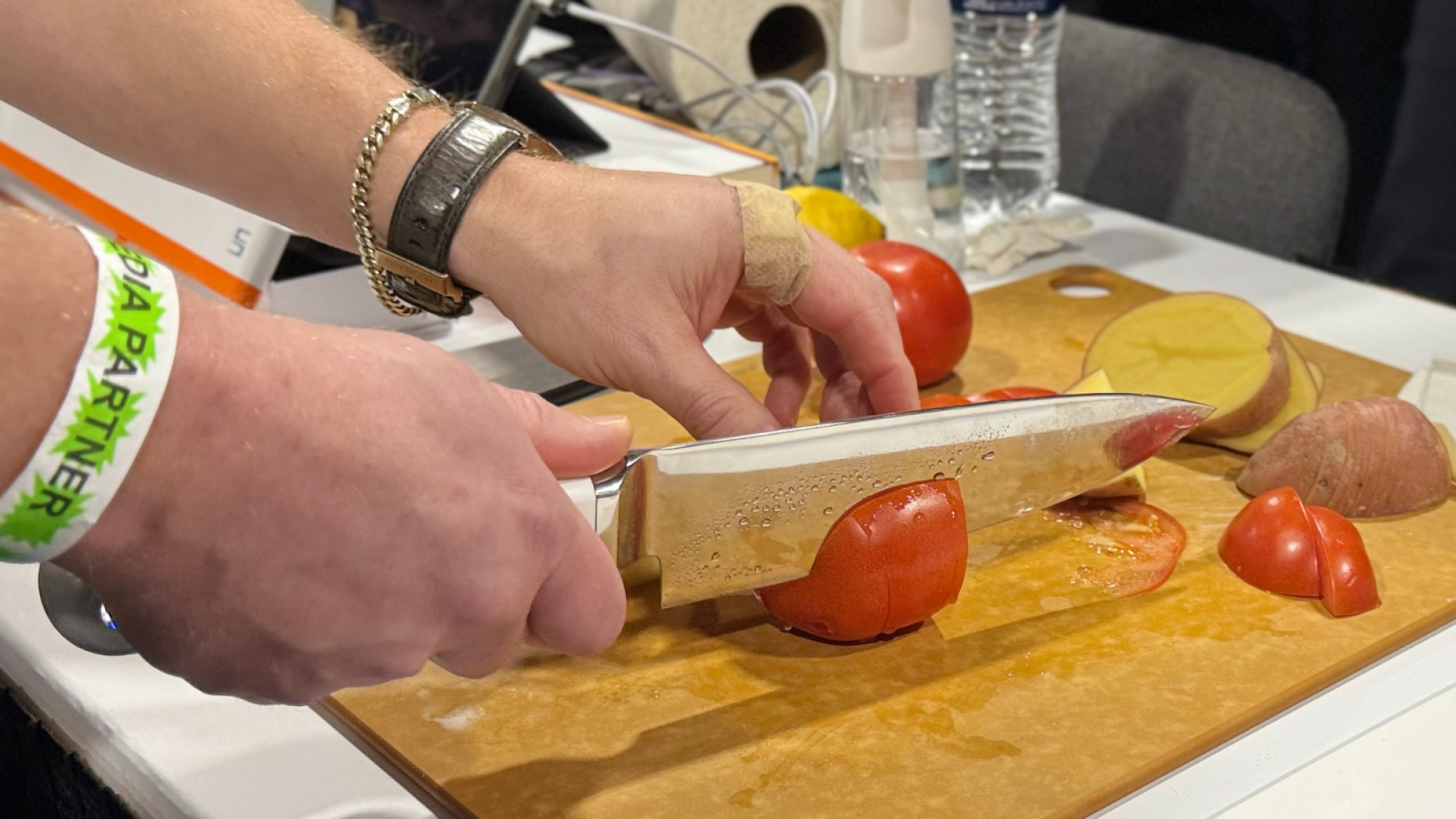 a man slicing a tomato with the Seattle Ultrasonics C-200 UltraSonic Chef's Knife