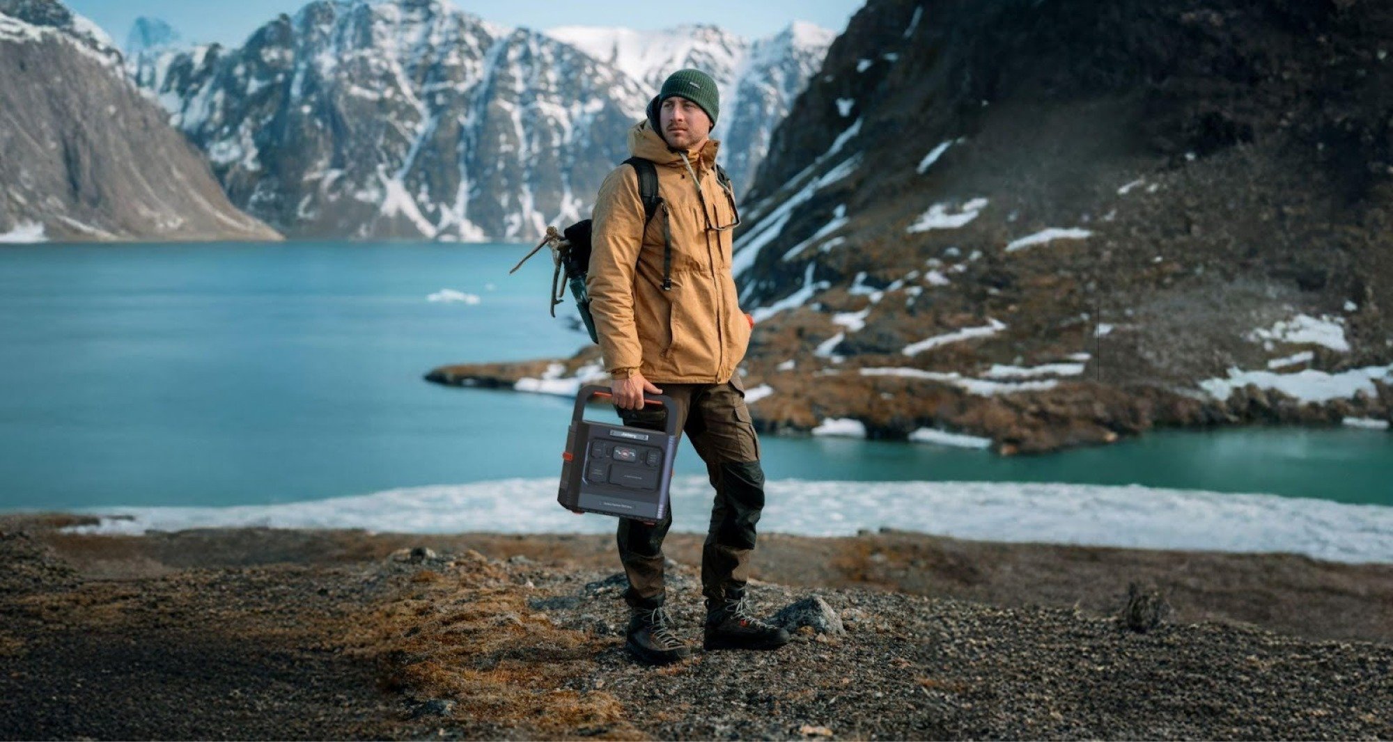 man holding jackery explorer 1500 ultra outside mountain lake